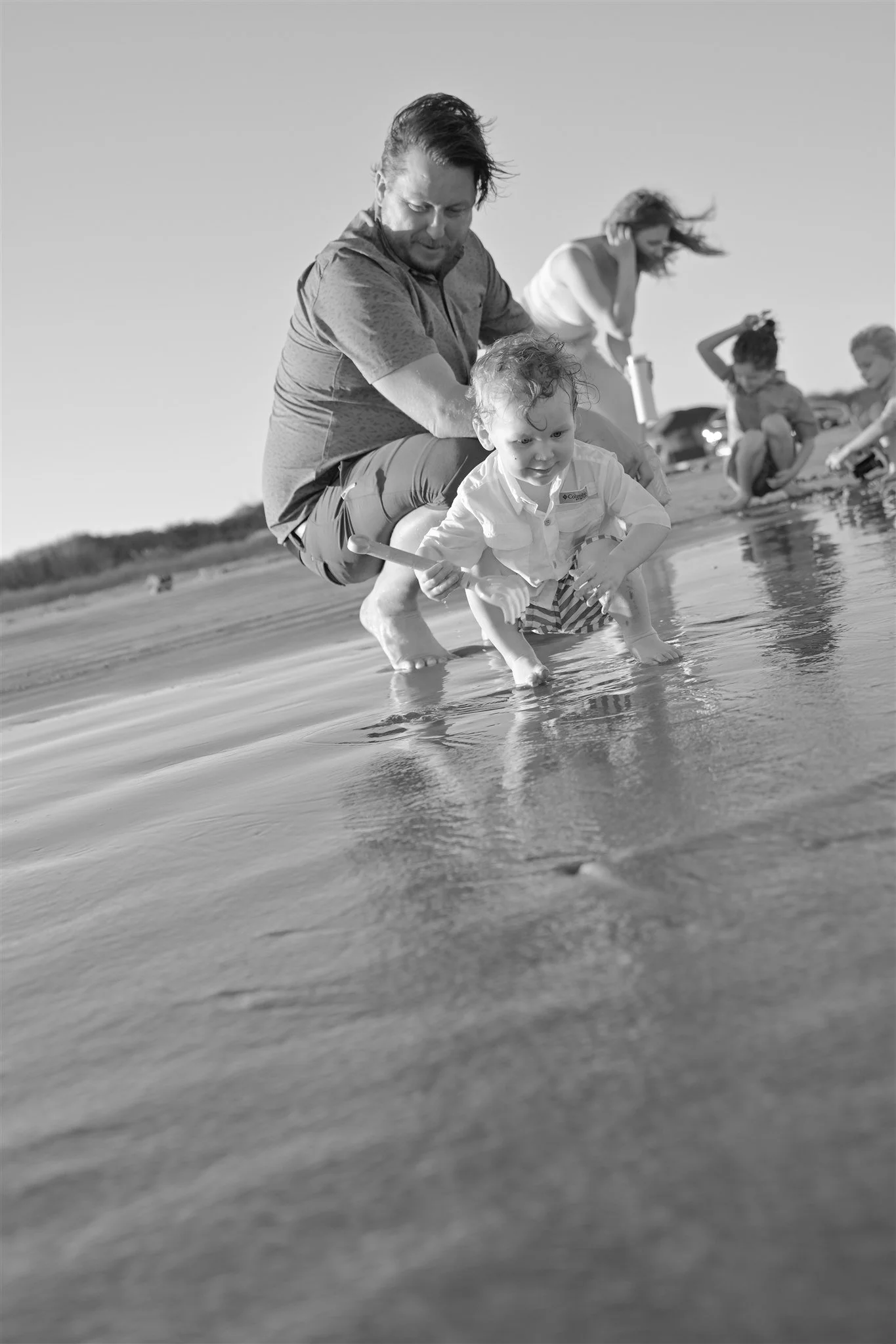 houston family playing at the beach at sunset