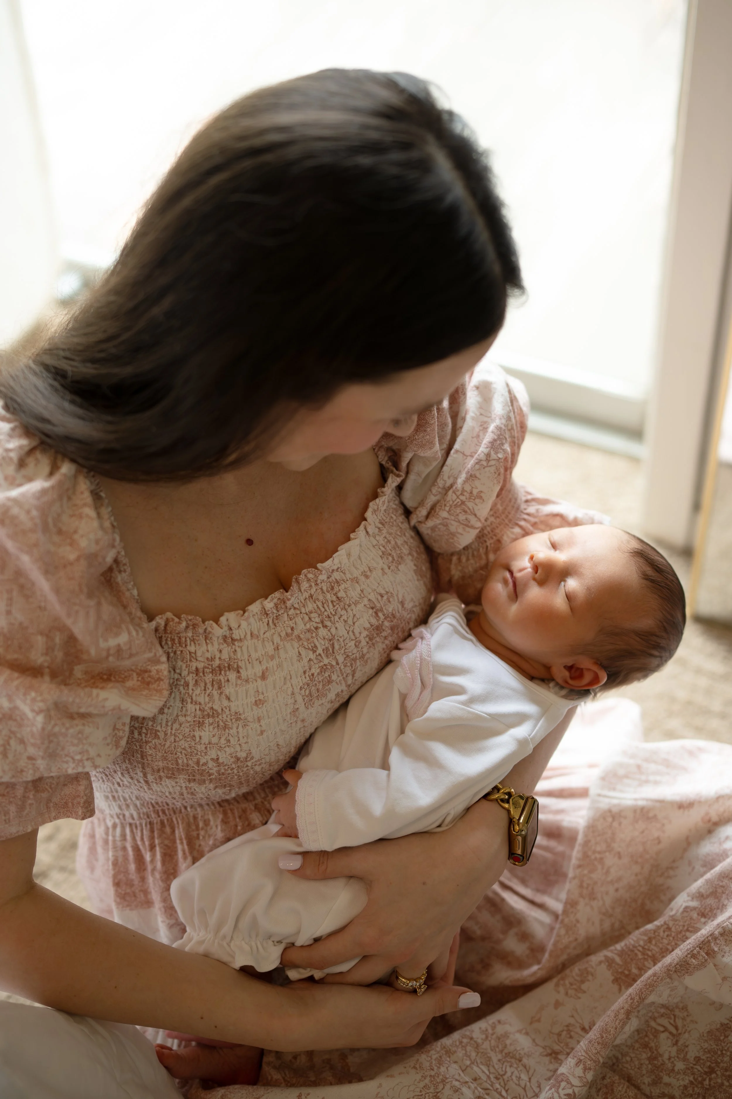 houston mom holding newborn baby at home