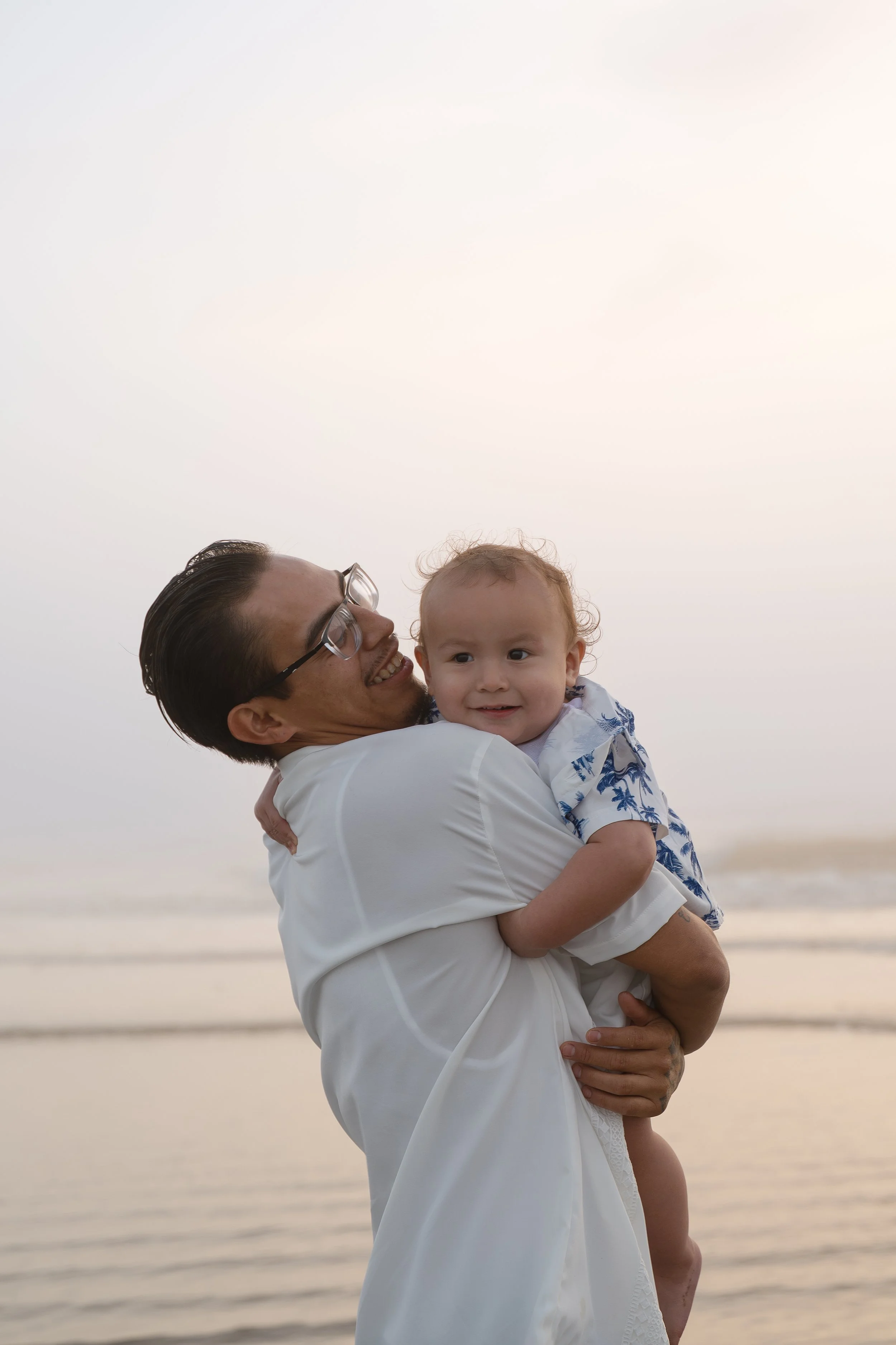 dad and young boy playing at the beach Galveston