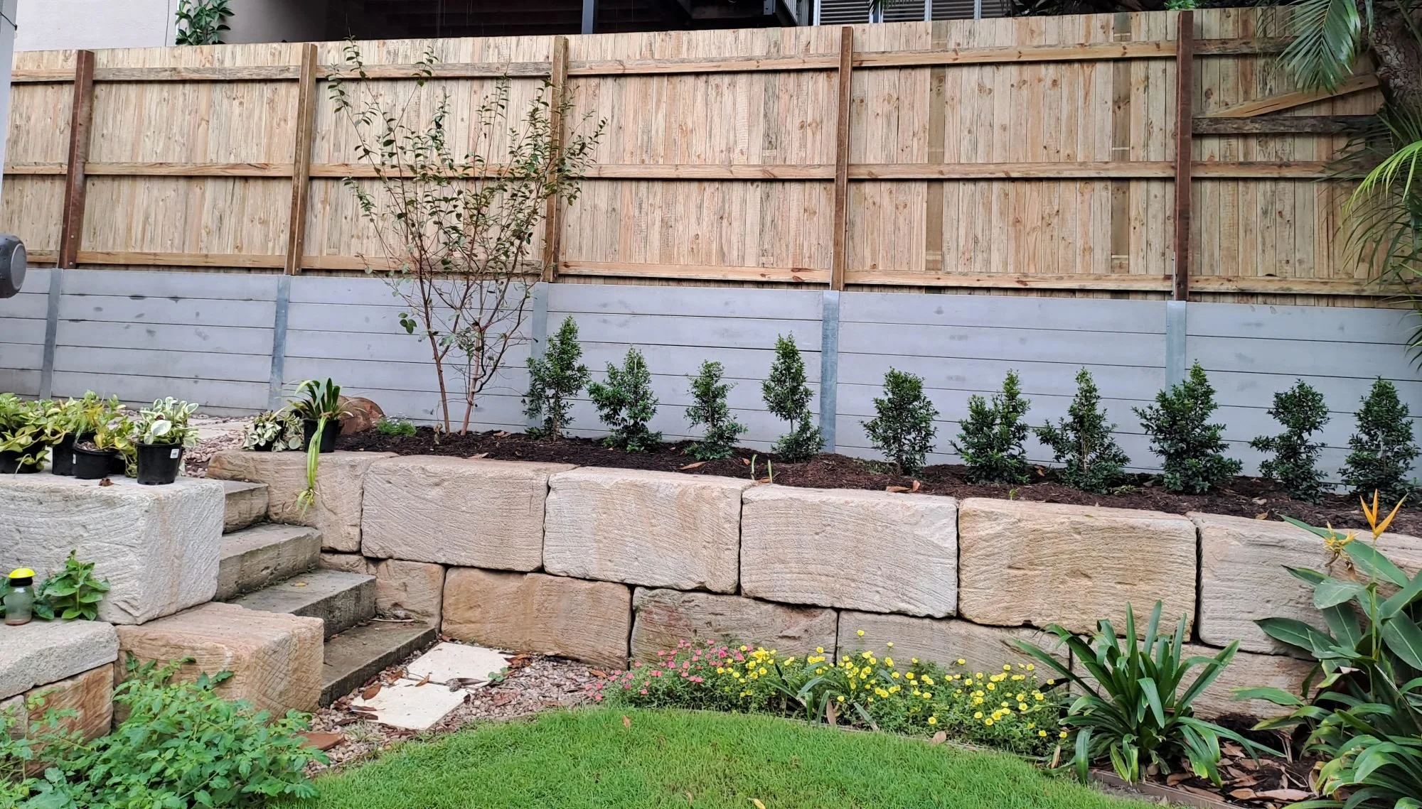 Sandstone block retaining wall construction by Fascon Renovations Sydney