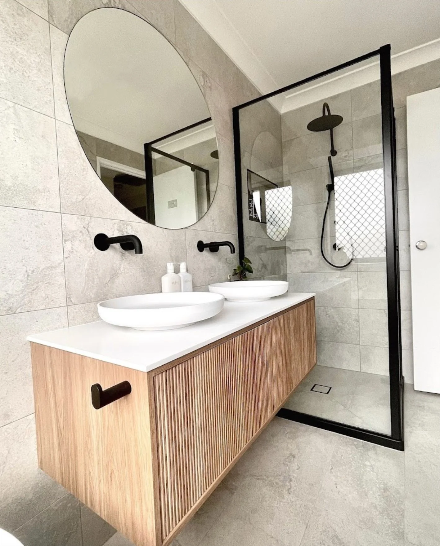 Modern bathroom renovation with double vanity and glass shower by Fascon Renovations Sydney