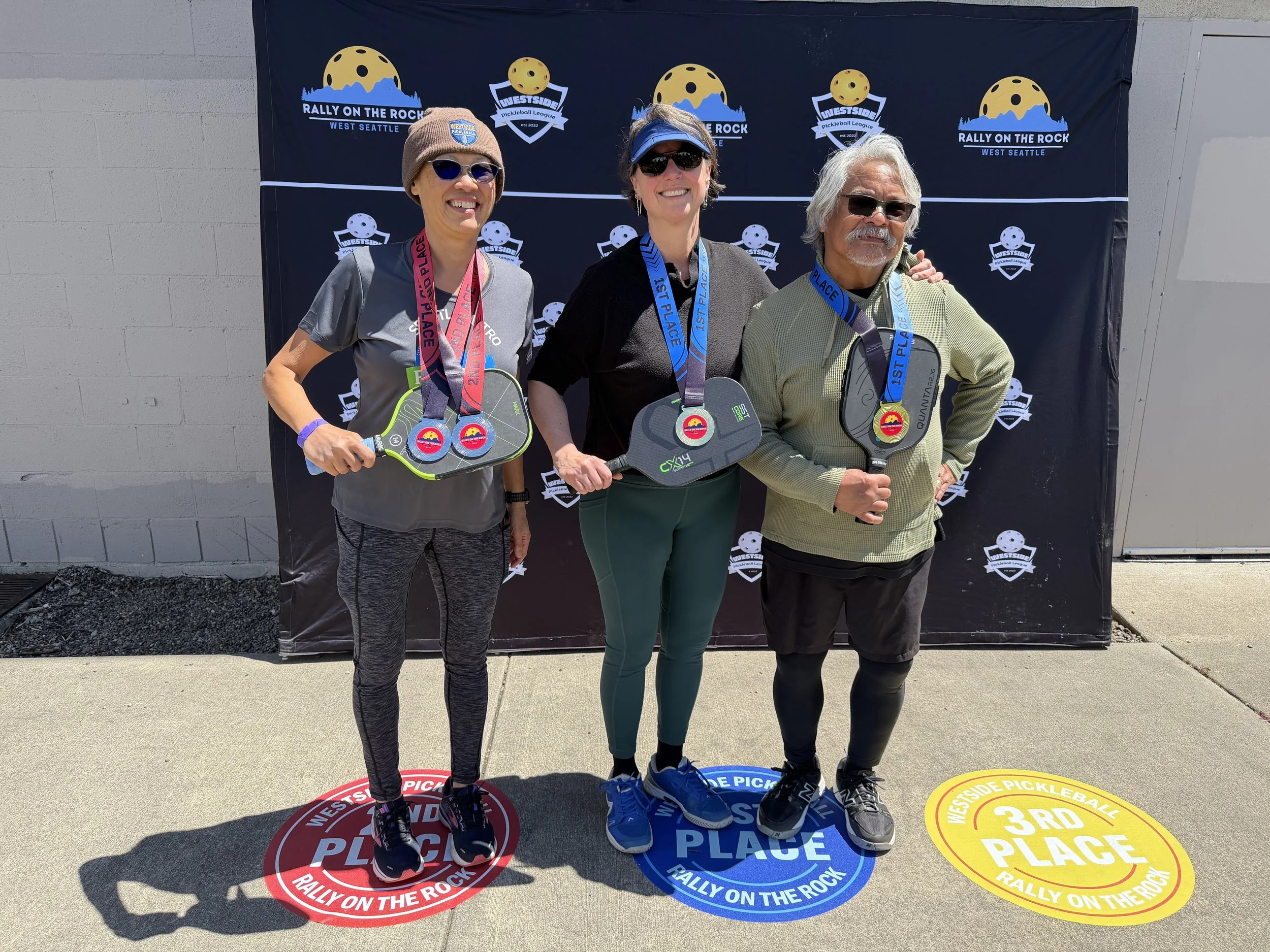 RALLY ON THE ROCK JUNE 2026:  Mixed Doubles, 3.0, 50-59    ~   SILVER: Josephine Wong (left) & Justin.   ~   GOLD: Jen Mandel (center) & Robert Lopez (right).   ~   BRONZE: Lan & Vu.