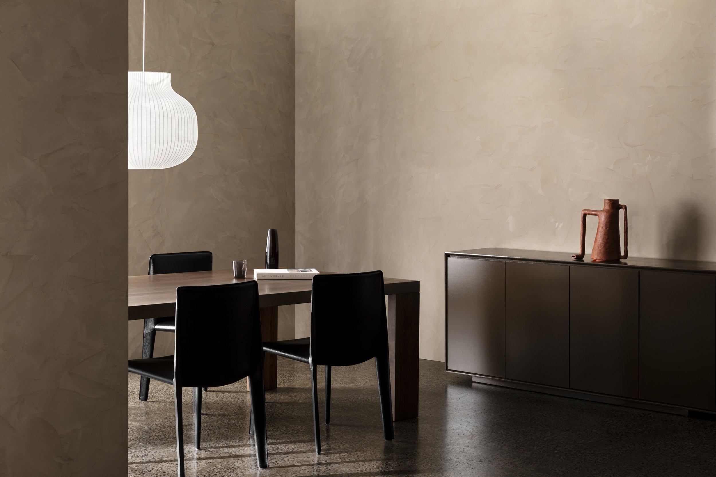 The high gloss reflective finish of the sideboard was juxtaposed with the fine organic texture of the walls.