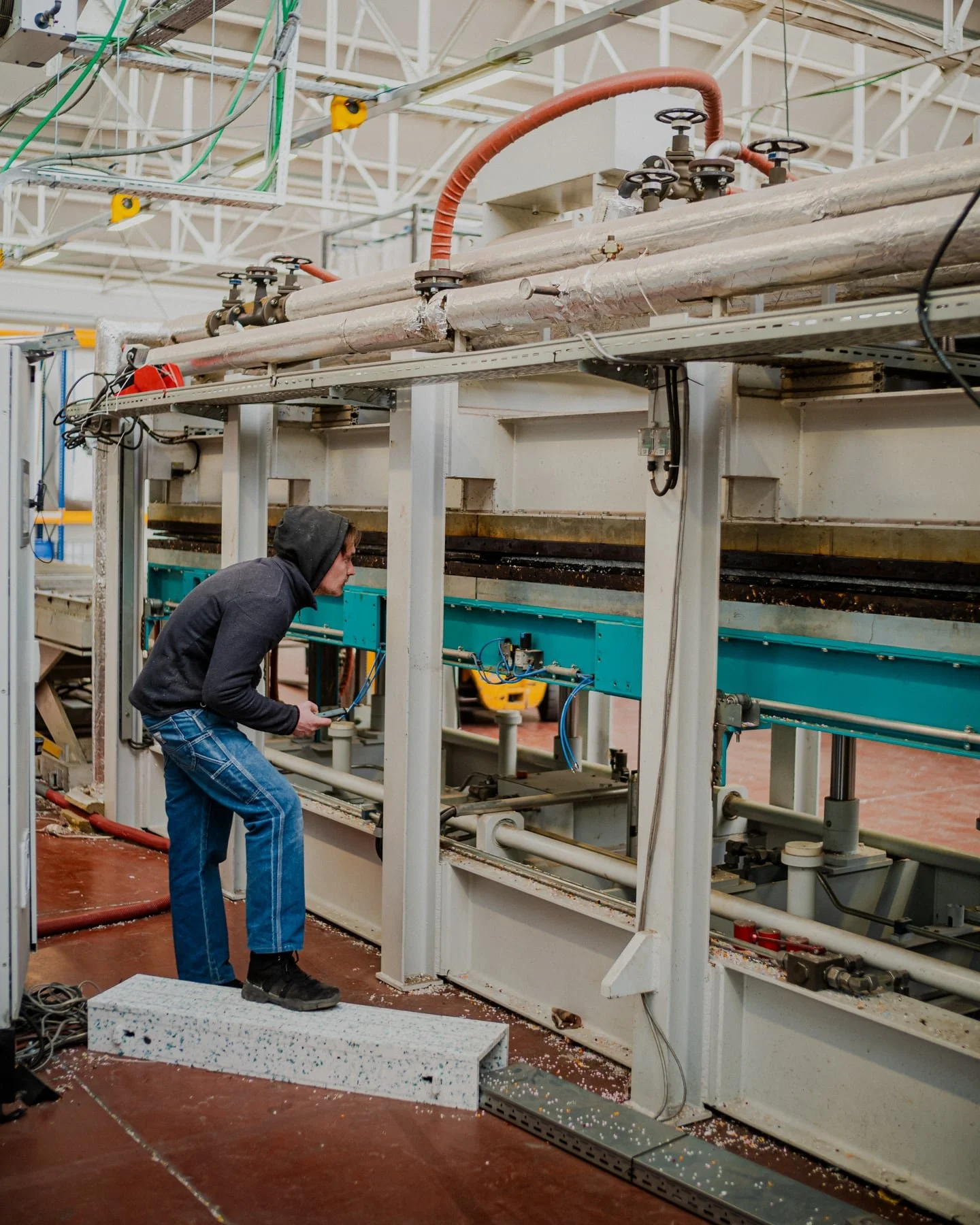 Ouvrier devant une grande presse industrielle
