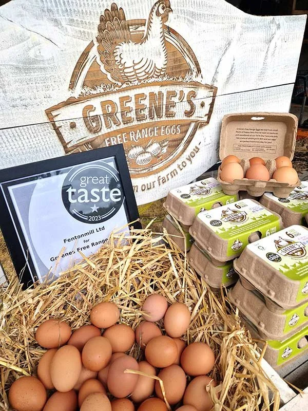 Display of free-range eggs from Greene's farm, with cartons and a basket of eggs, a sign from Greene's farm, and a 'great taste 2023' award plaque.