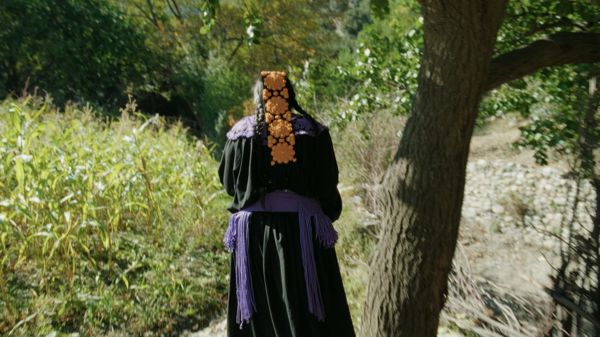 Kalash woman wearing shutshut walking in the Forest
