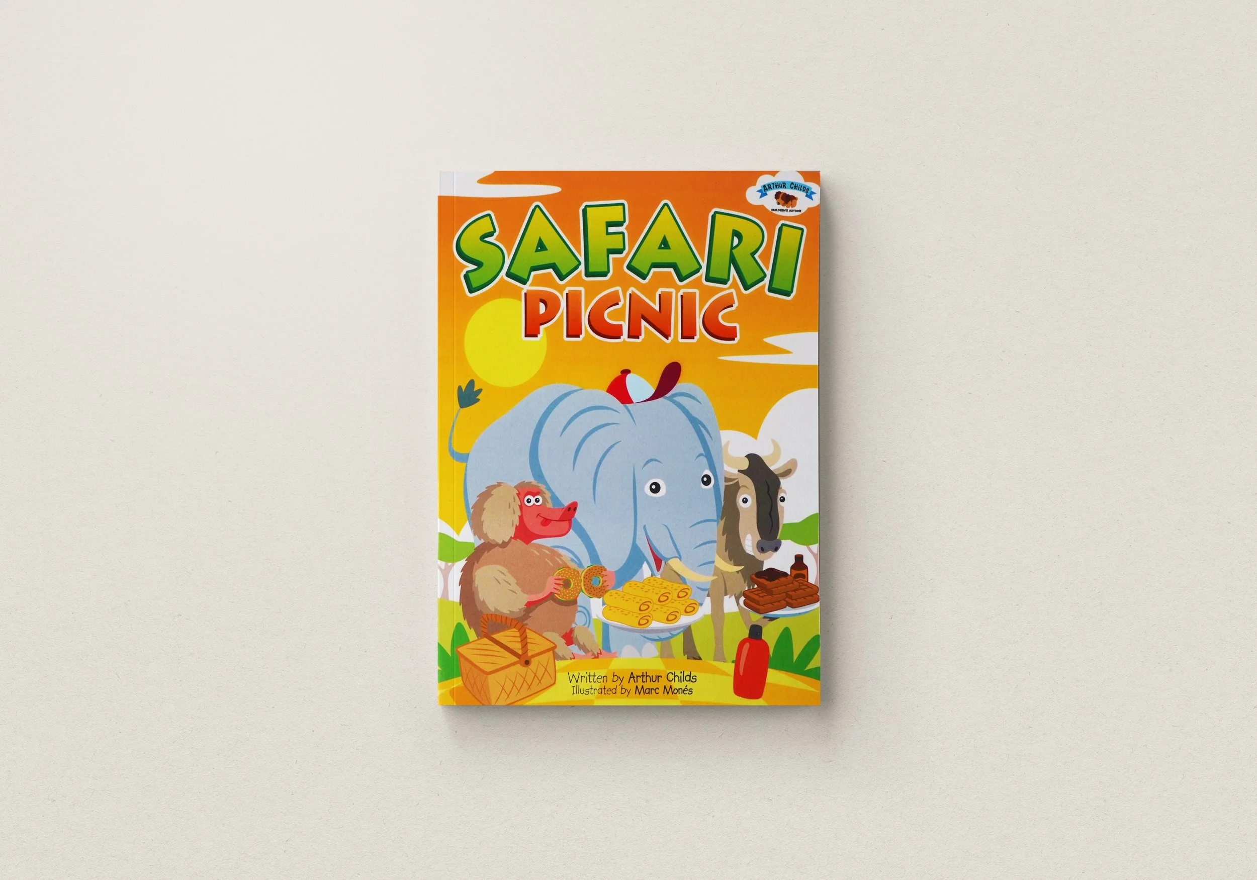 Children's book cover titled 'Safari Picnic' with illustrated animals having a picnic, including an elephant, a baboon, and a wildebeest under a bright orange sky.