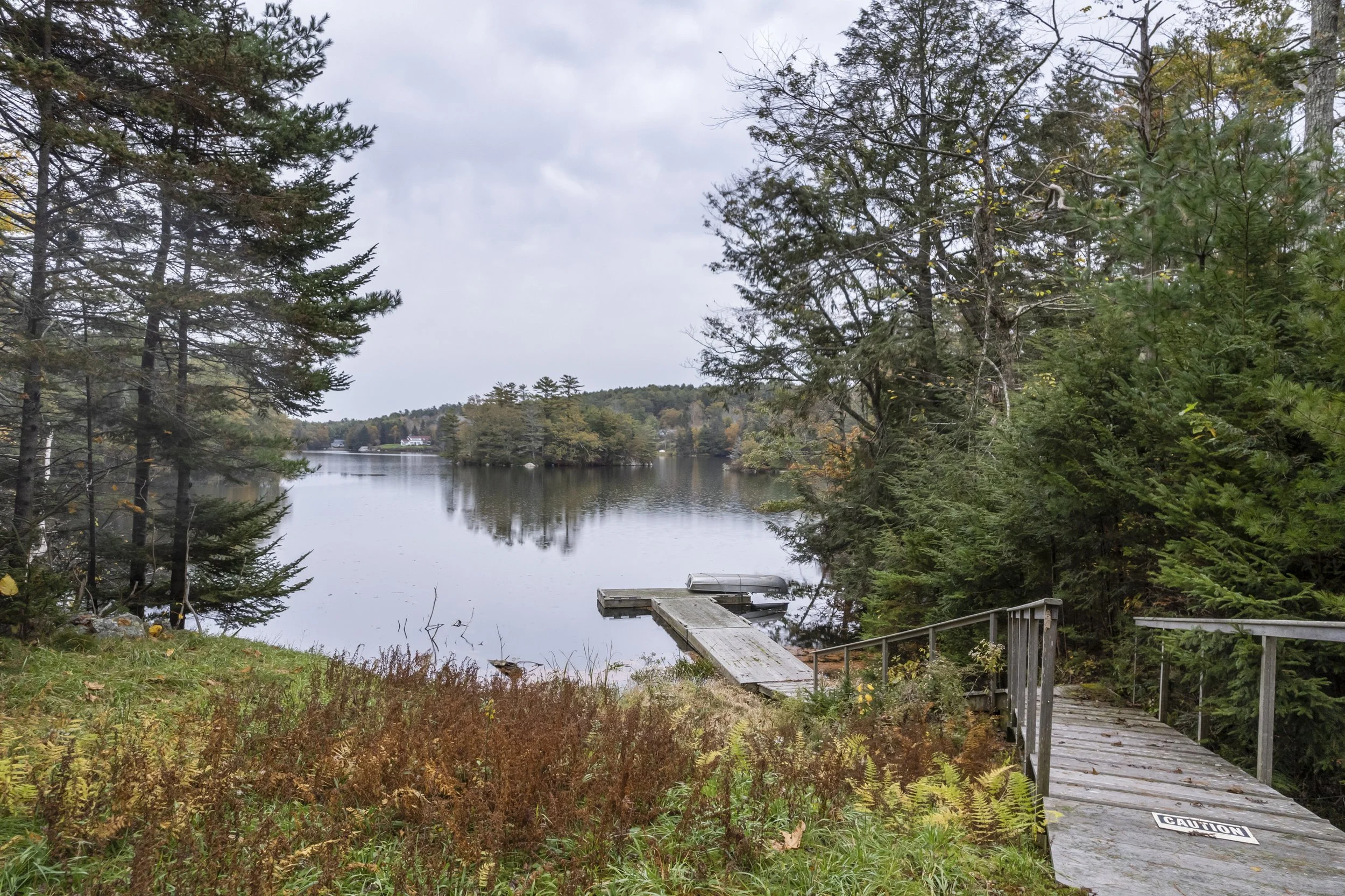 The modern guest cottage offers a soaring two story living room with wood burning fireplace, fresh/crisp kitchen and cozy loft. When you are not busy in the barn, you can walk down the lawn to West Harbor Pond.