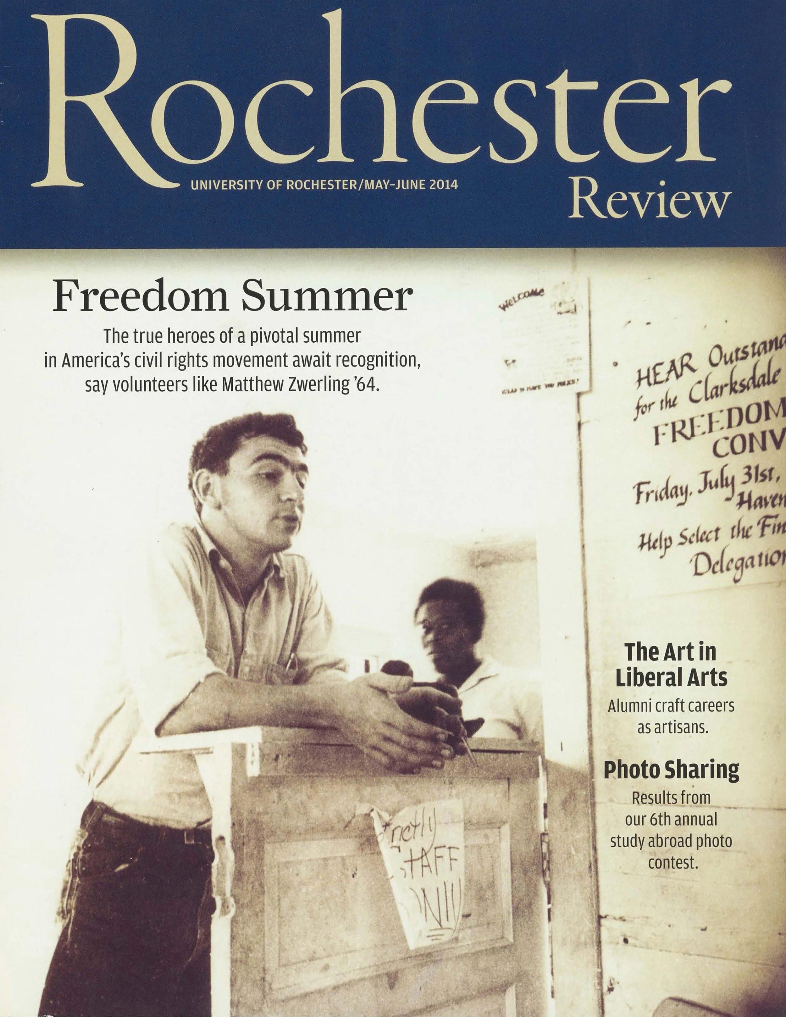 Cover of the Rochester Review magazine from May-June 2014, featuring a black-and-white photograph of a young man speaking into a microphone at a table during a civil rights event.