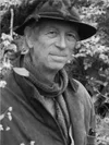 Man wearing a hat in a field, black and white photo