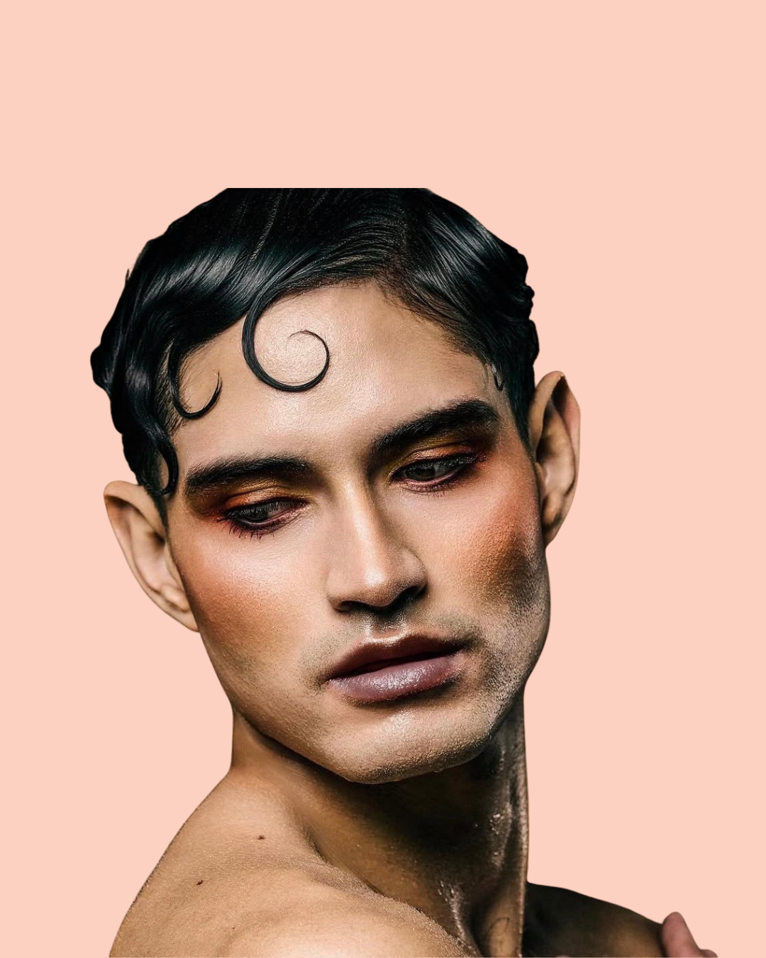 person with black styled hair and bronze makeup