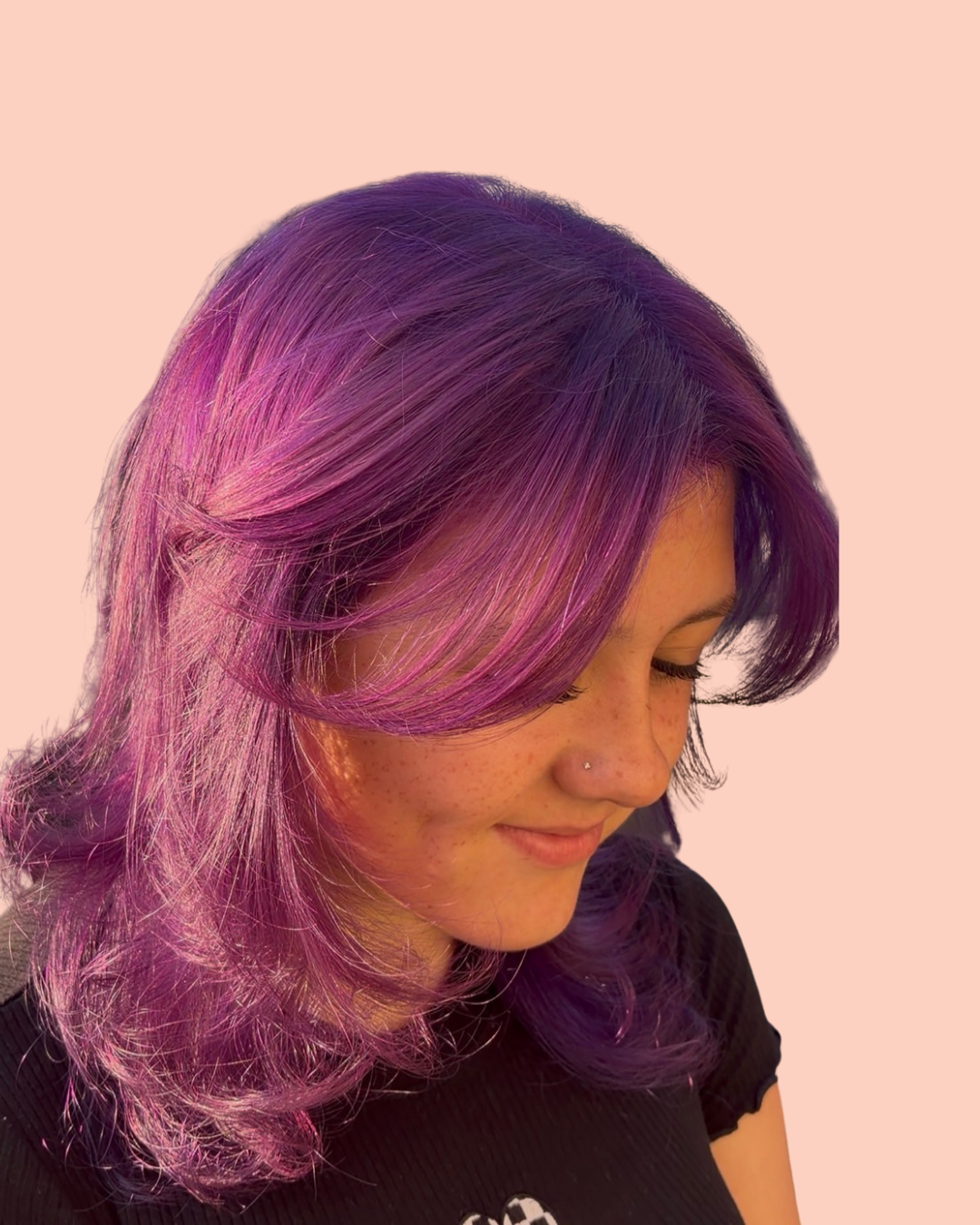 person with purple hair and nose ring