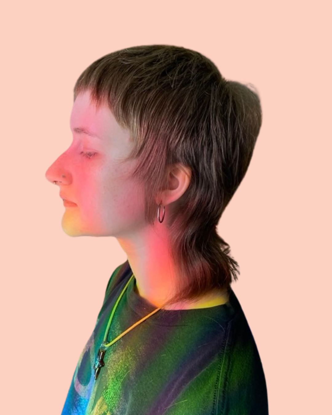 person with nose ring  earrings and medium brown short length hair