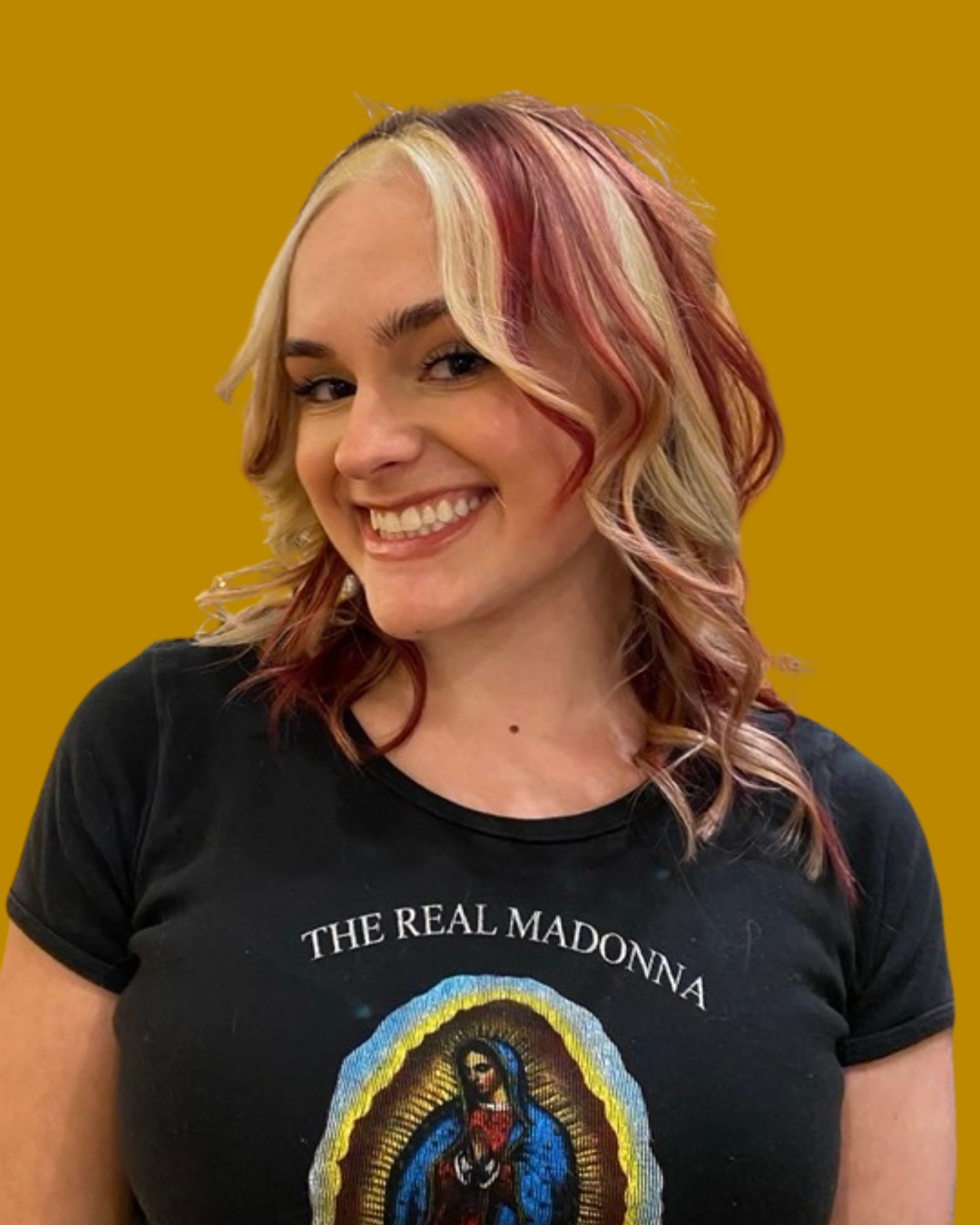 person with bright smile and blonde hair with red highlights