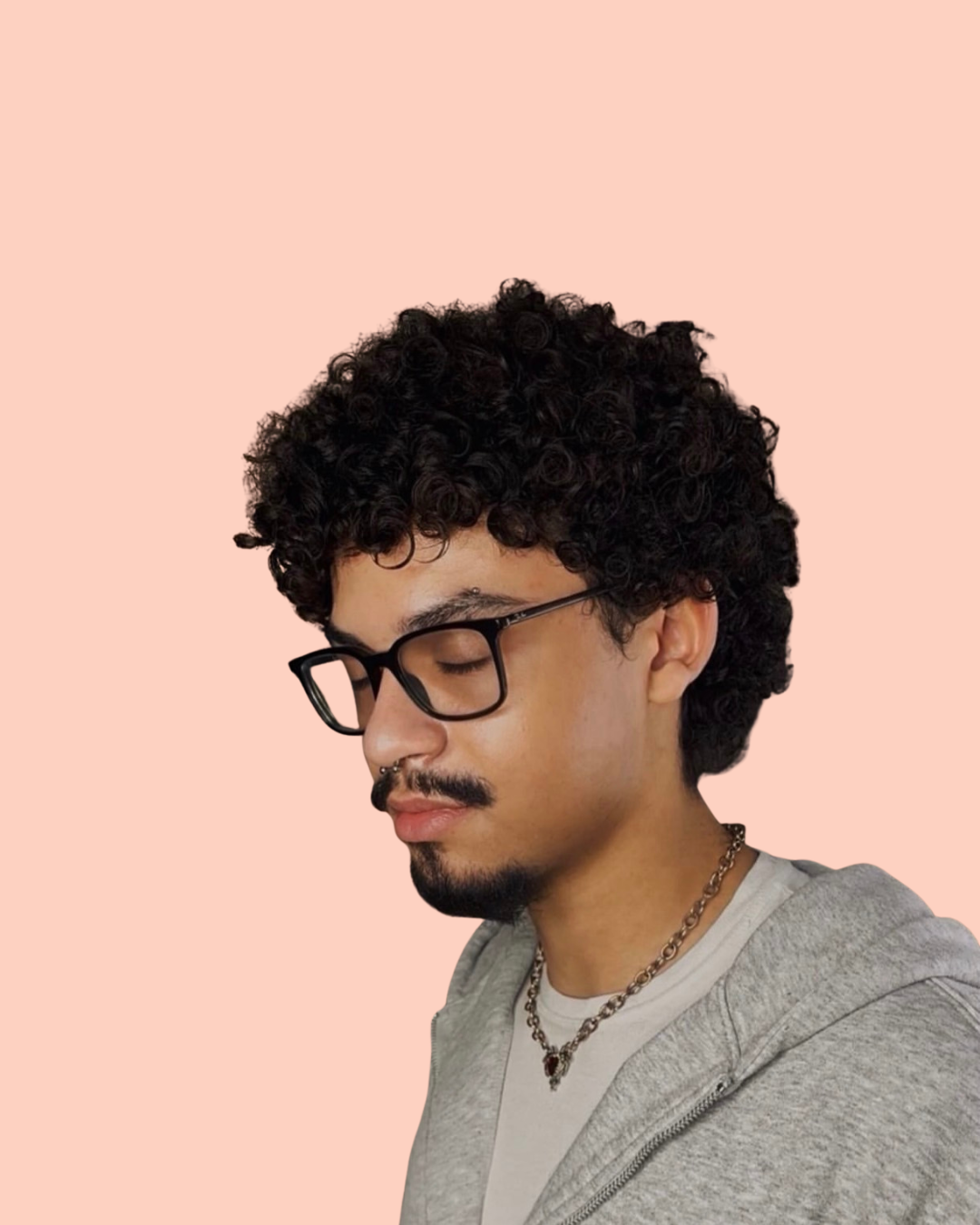 person with curly brown hair and glasses