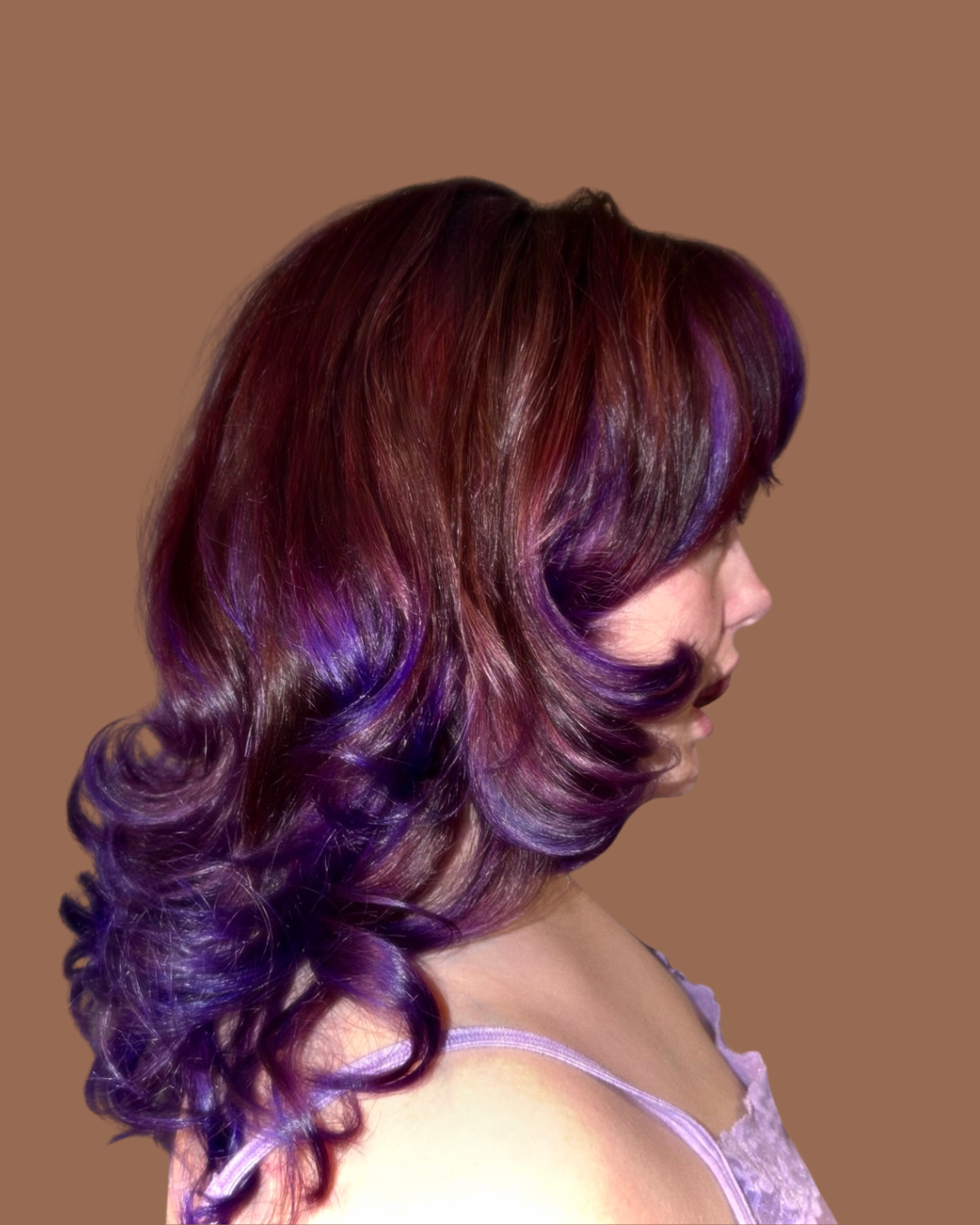 person with violet highlights looks away from camera