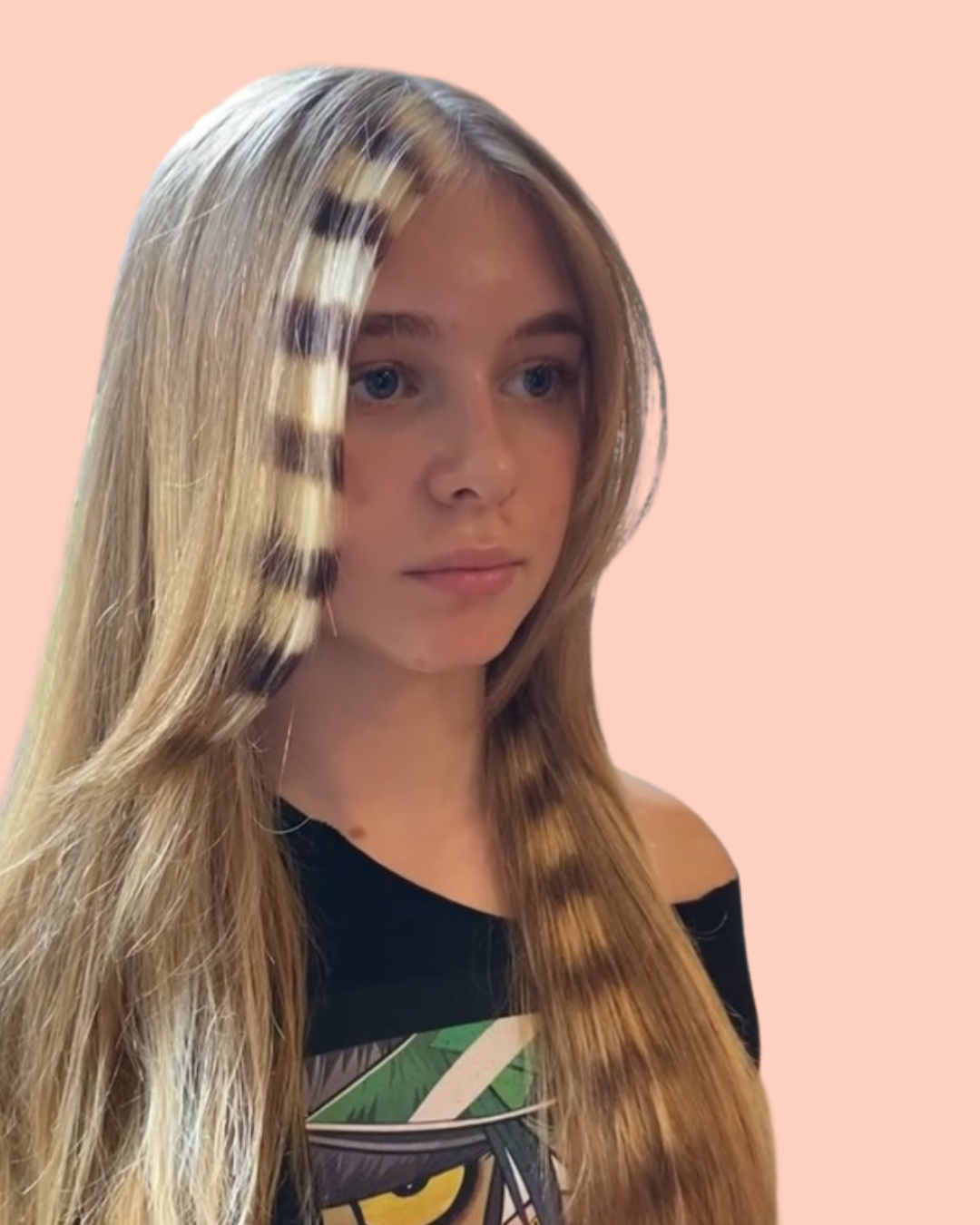 person with blonde hair and blonde and brown streaks in front of hair