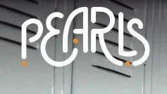 Close-up of the word 'PEARLIS' written in white on a gray wall