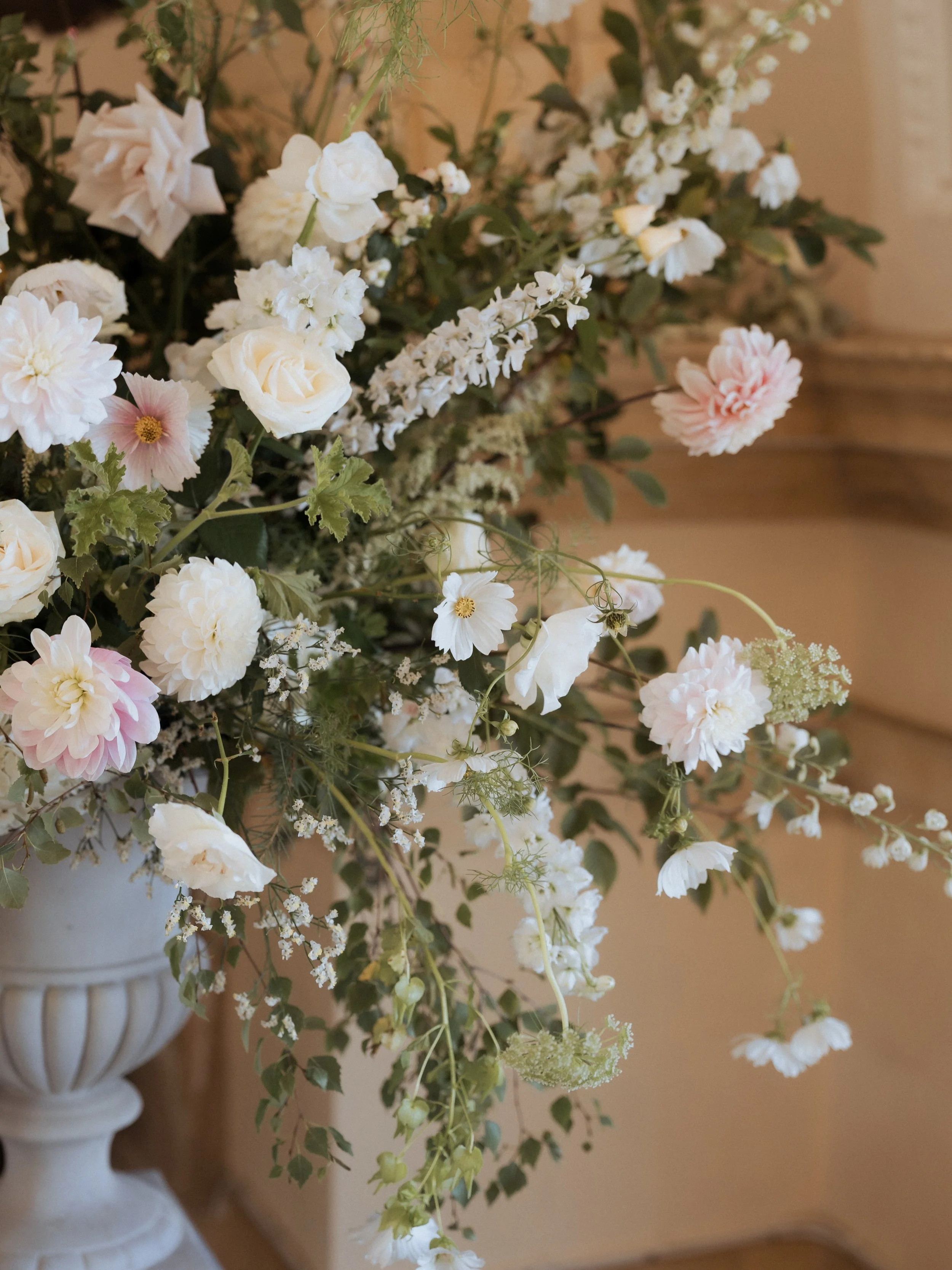September in white, blush and green.

We will never get bored of creating traditional urns and plinths to frame a ceremony. This church is special. Saved when the area was flooded to create Rutland Water back in 1970. When the water level is high it 