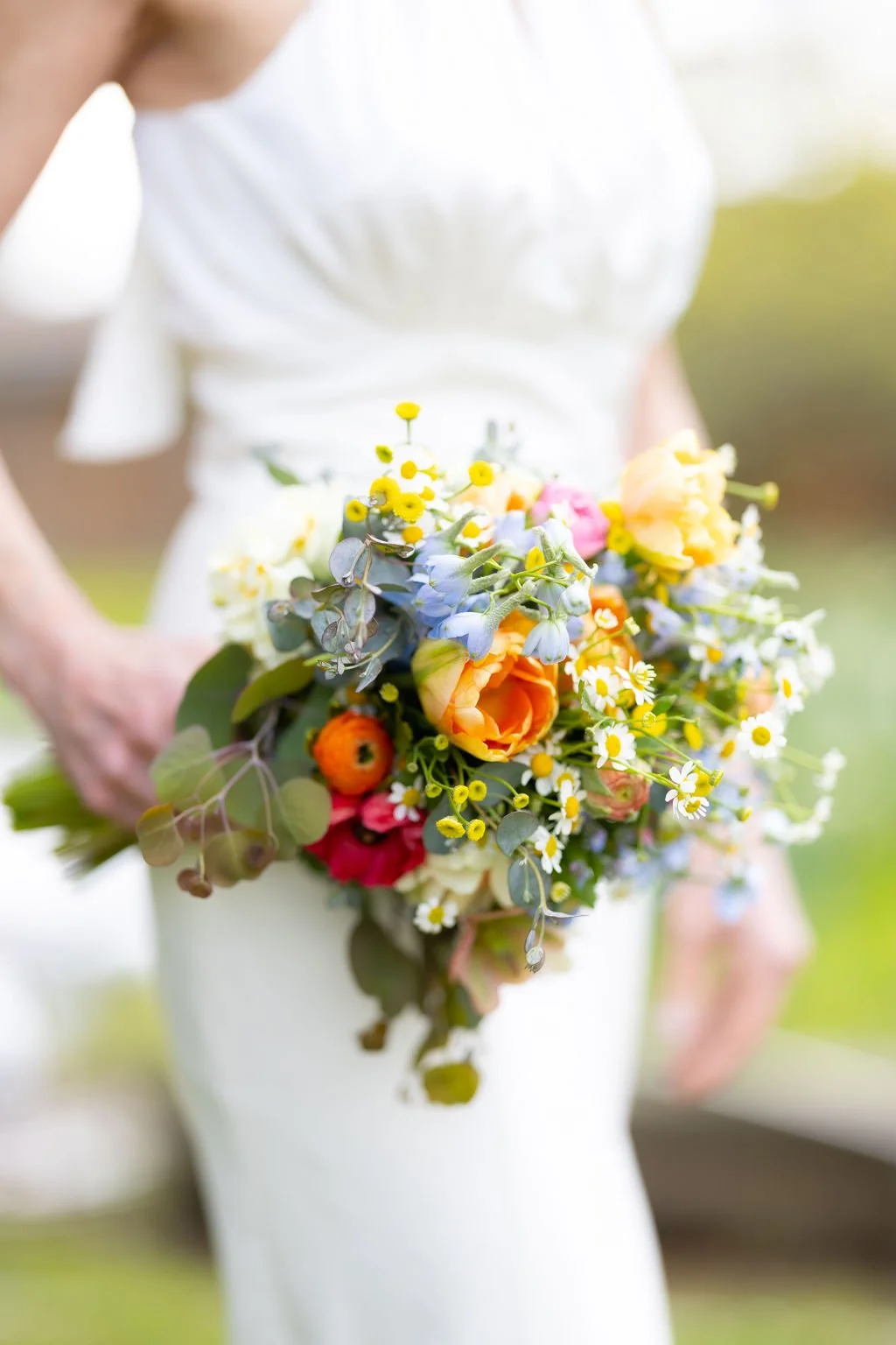 Sonoma bride featuring bouquet of spring flowers including tulips, ranunculus and yellow butterfly ranunculus