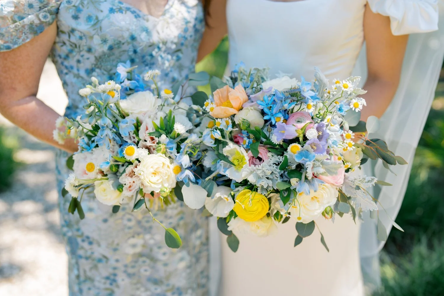 Bride and bridesmaid holding soft colorful garden style bouquets with seasonal Sonoma wedding flowers