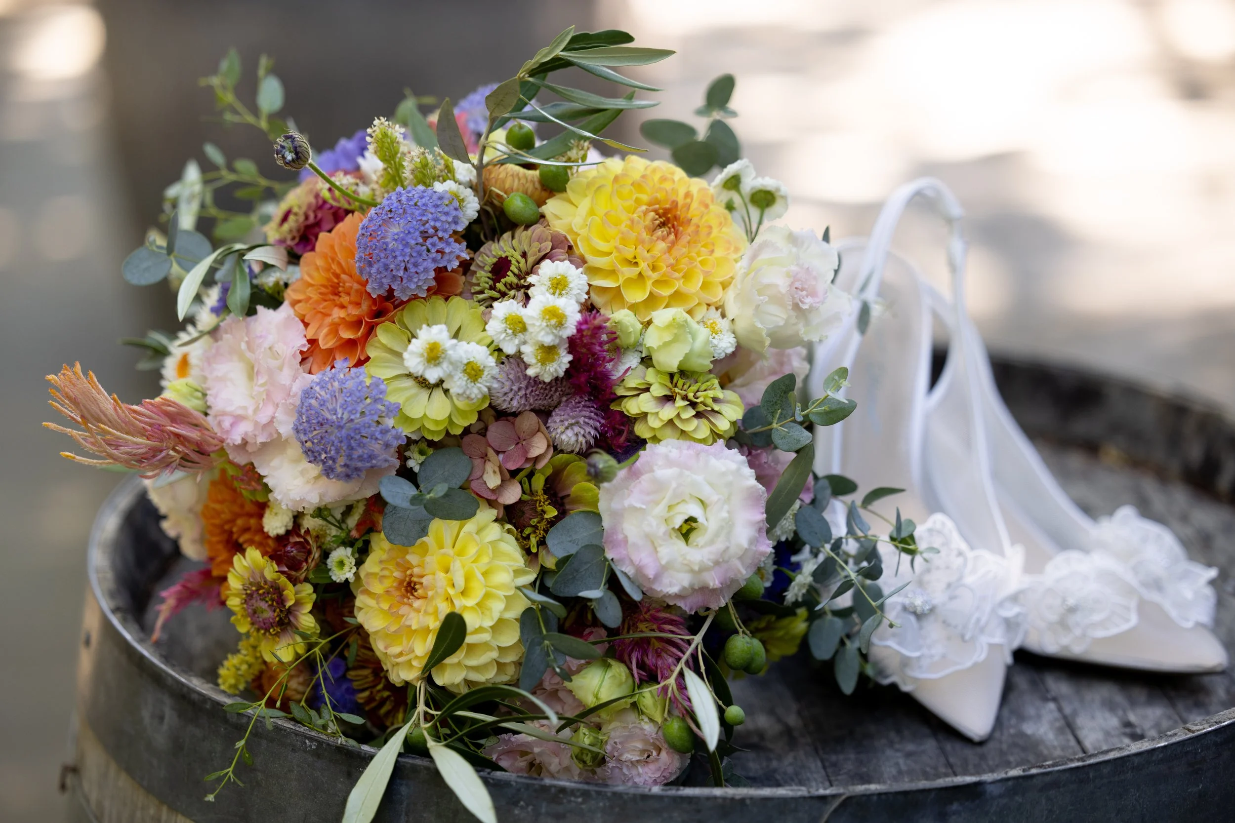 Bridal bouquet featuring seasonal flowers arranged beside wedding shoes at a Sonoma County wedding.