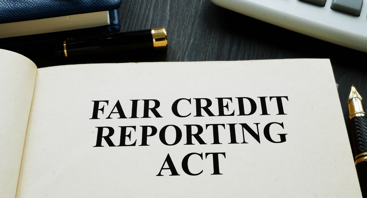 Open book with the text "FAIR CREDIT REPORTING ACT" on a page.