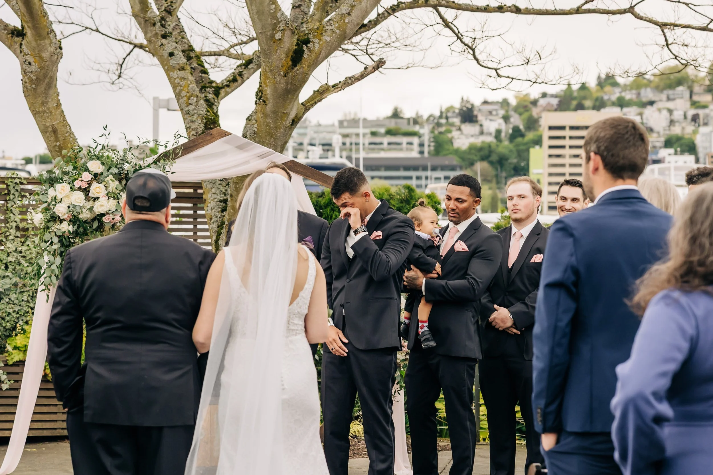 Groom crying as bride walks down the aisle at Dockside at Dukes.