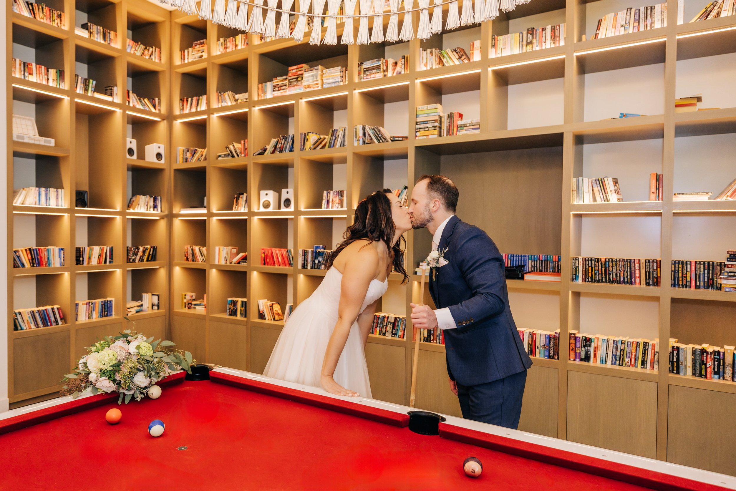 Kiss at pool table at Hotel W Bellevue