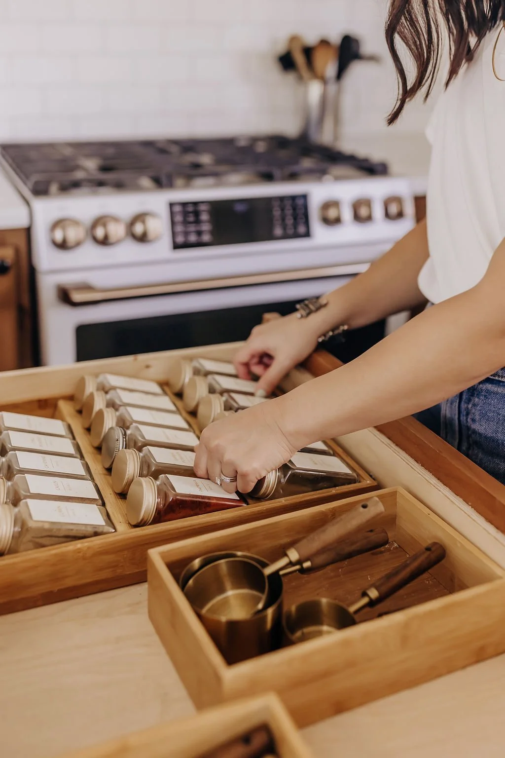 Ami Teodosio organizing a spice drawer in a San Antonio home