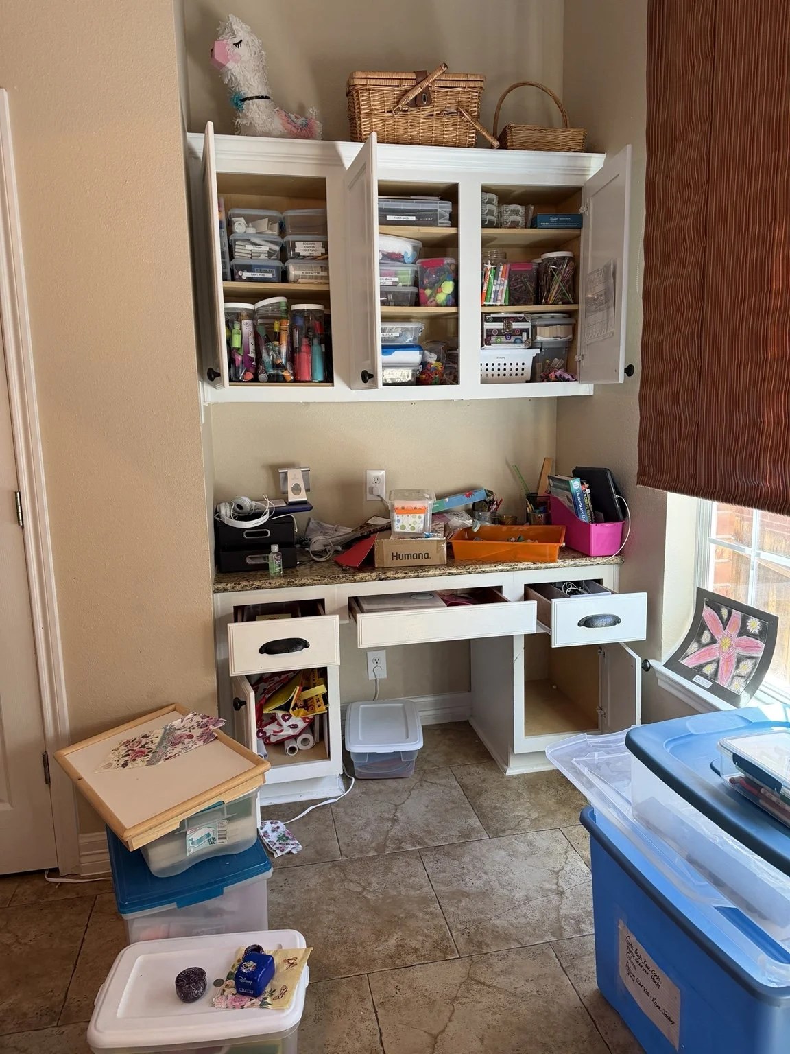 Cluttered craft room before professional decluttering and organizing in San Antonio
