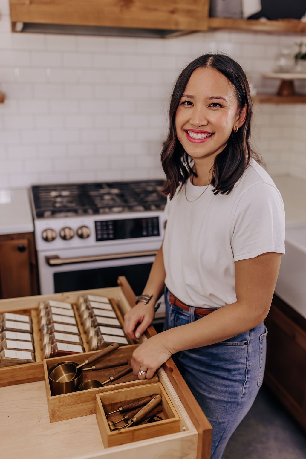 Ami Teodosio organizing a kitchen drawer during an unpacking and home setup project in San Antonio