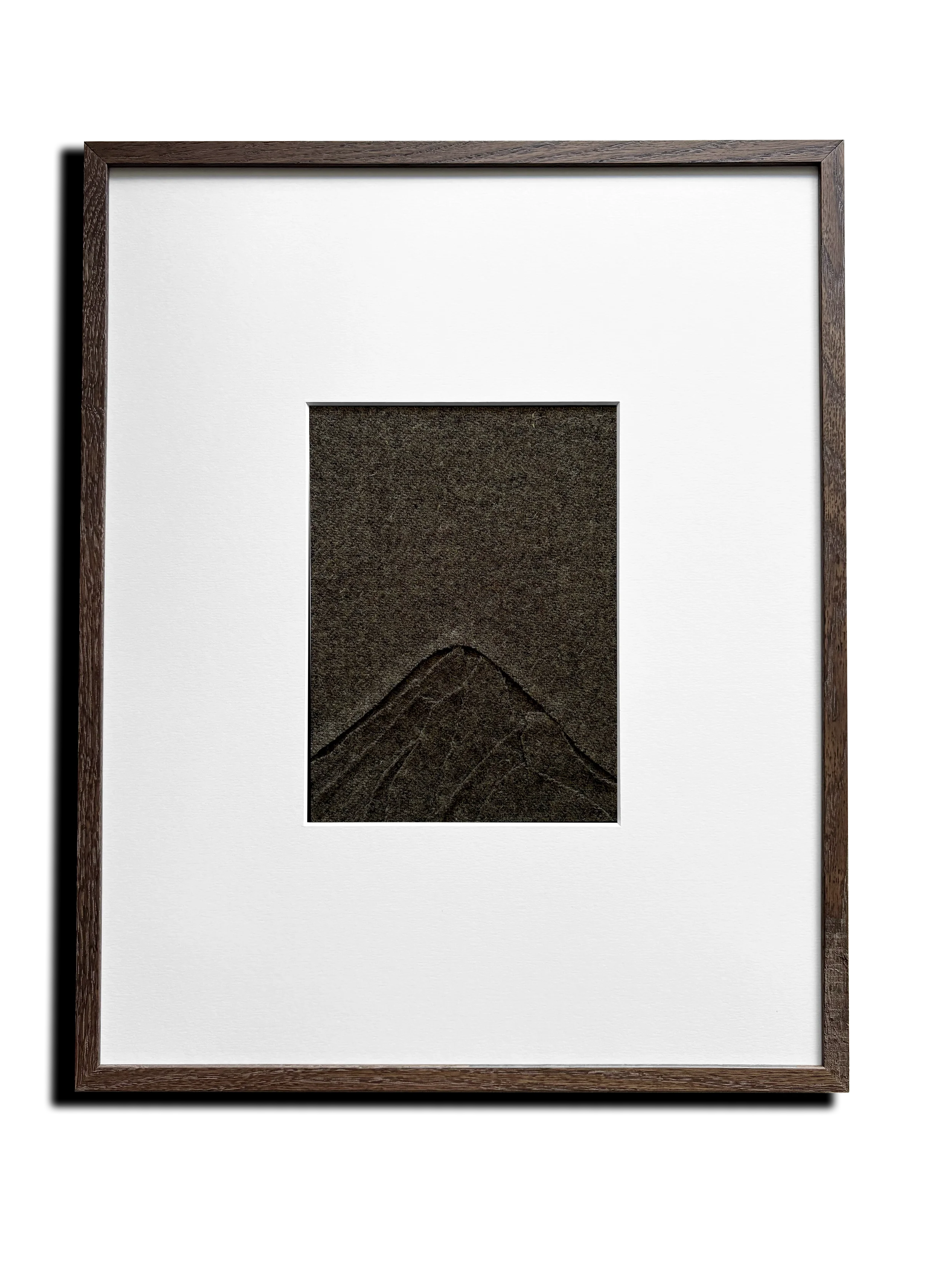 Hand sewn textile art created with 100% wool. Abstract landscape painting. Title: 'Above a Mountain'. Color: Mud. Framed in dark oak wood with passe-partout. 40x50cm