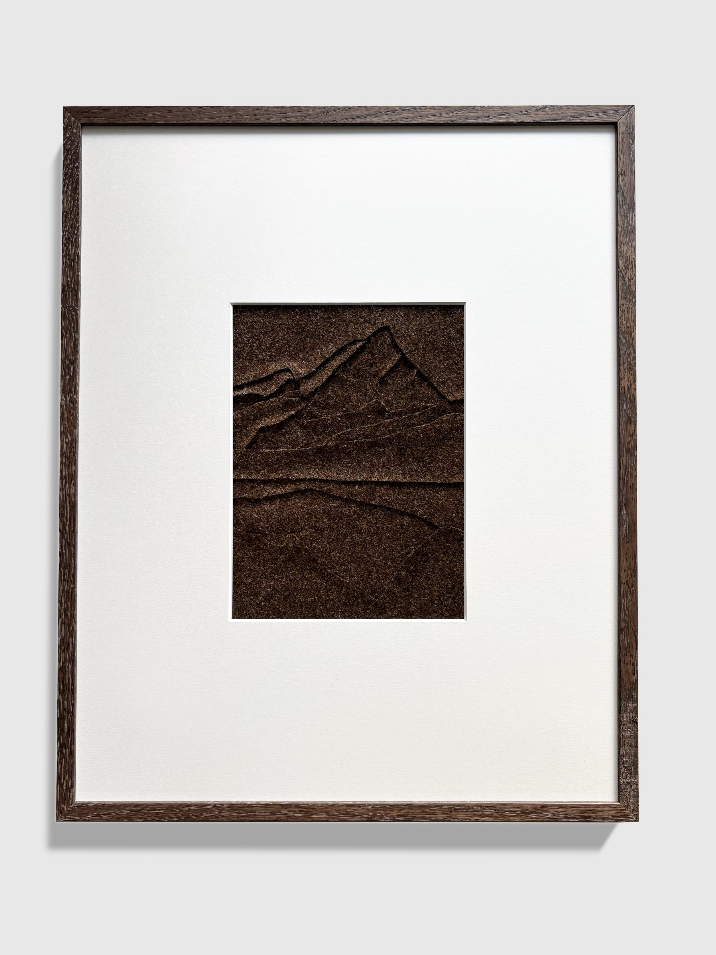 This textile artwork is an abstract representation of Lago Goillet, Italy. 100% wool. 100% hand sewn in the colour brown. Framed in dark oak wood without glass. Frame size is 40x50 cm. Passe-partout window is 17x23cm.