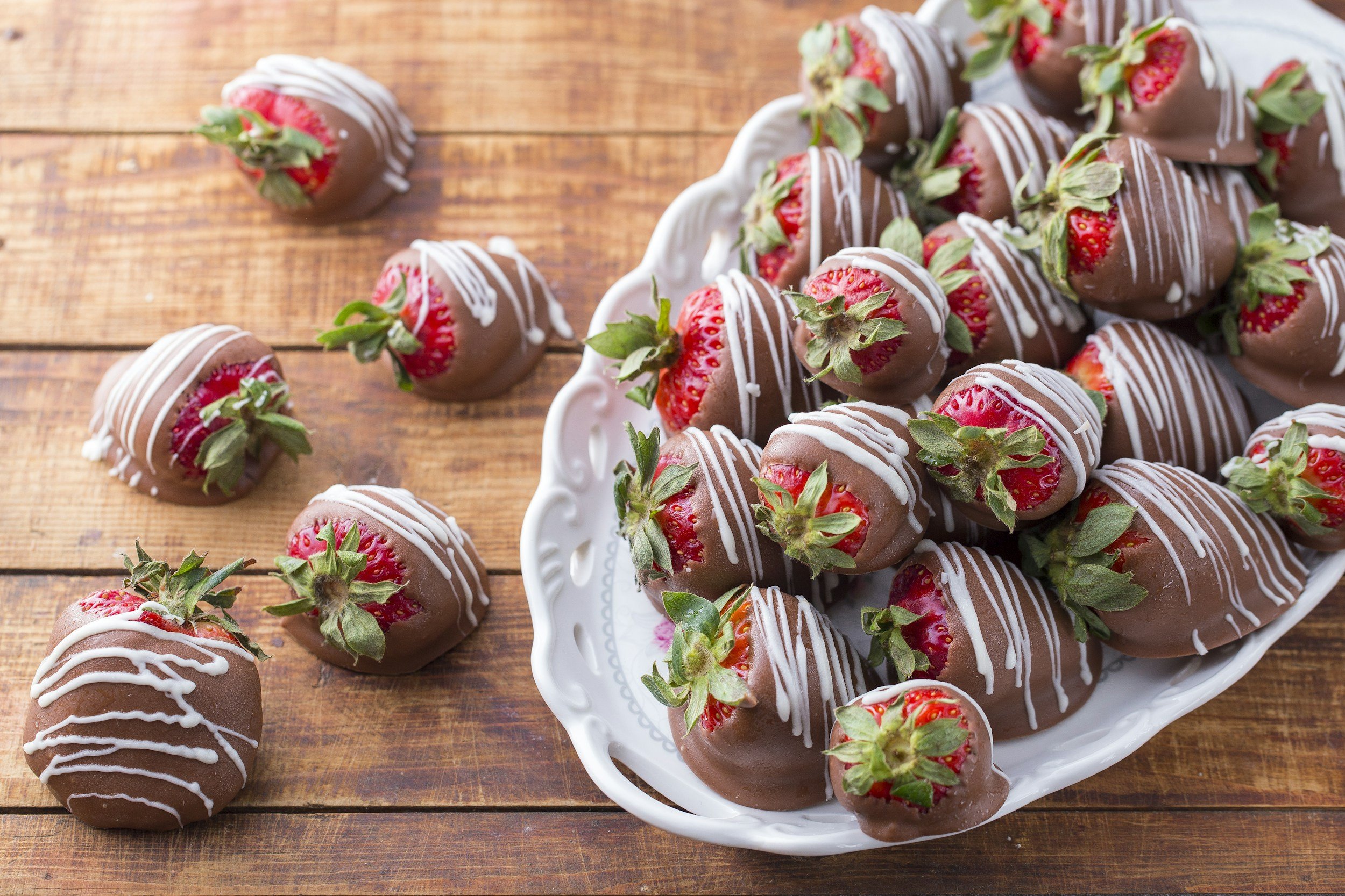 Strawberries dipped in milk chocolate with a white chocolate drizzle