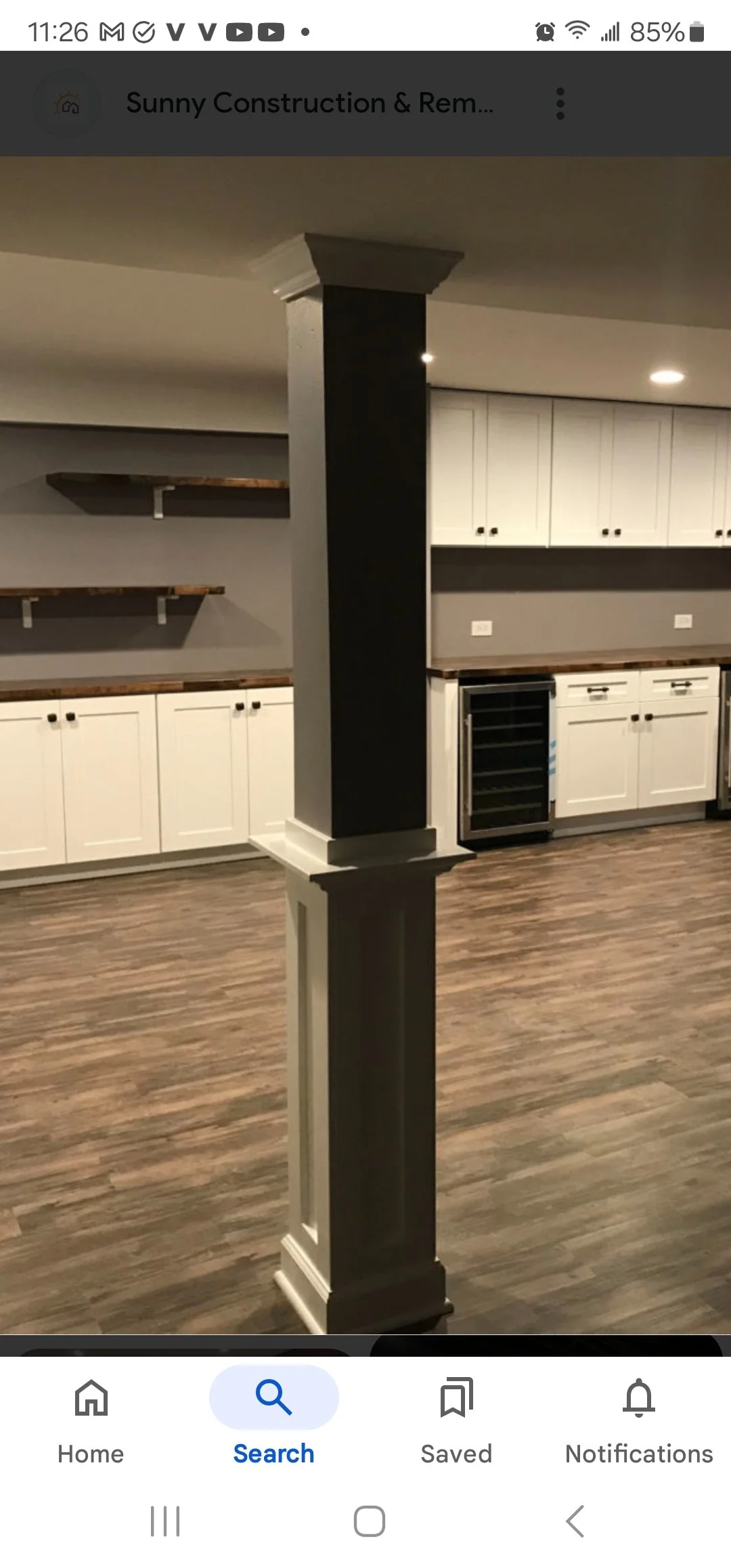 Complete basement renovation by MDA Residential LLC in Ridgewood, NJ, featuring custom cabinetry, built-in shelving, a decorative column, andstylish flooring for a modern and functional living space.