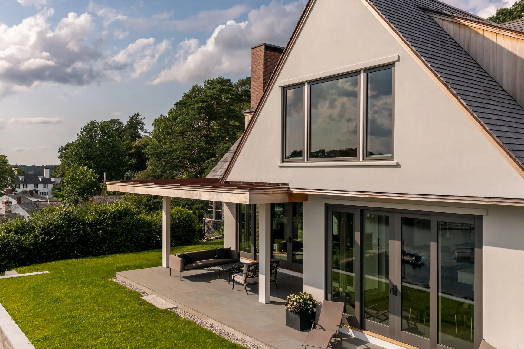 A refined coastal residence designed by Lindsey Architects, blending contemporary architecture with timeless New England character. This custom luxury home features expansive glazing, indoor-outdoor living spaces, and durable materials selected for t