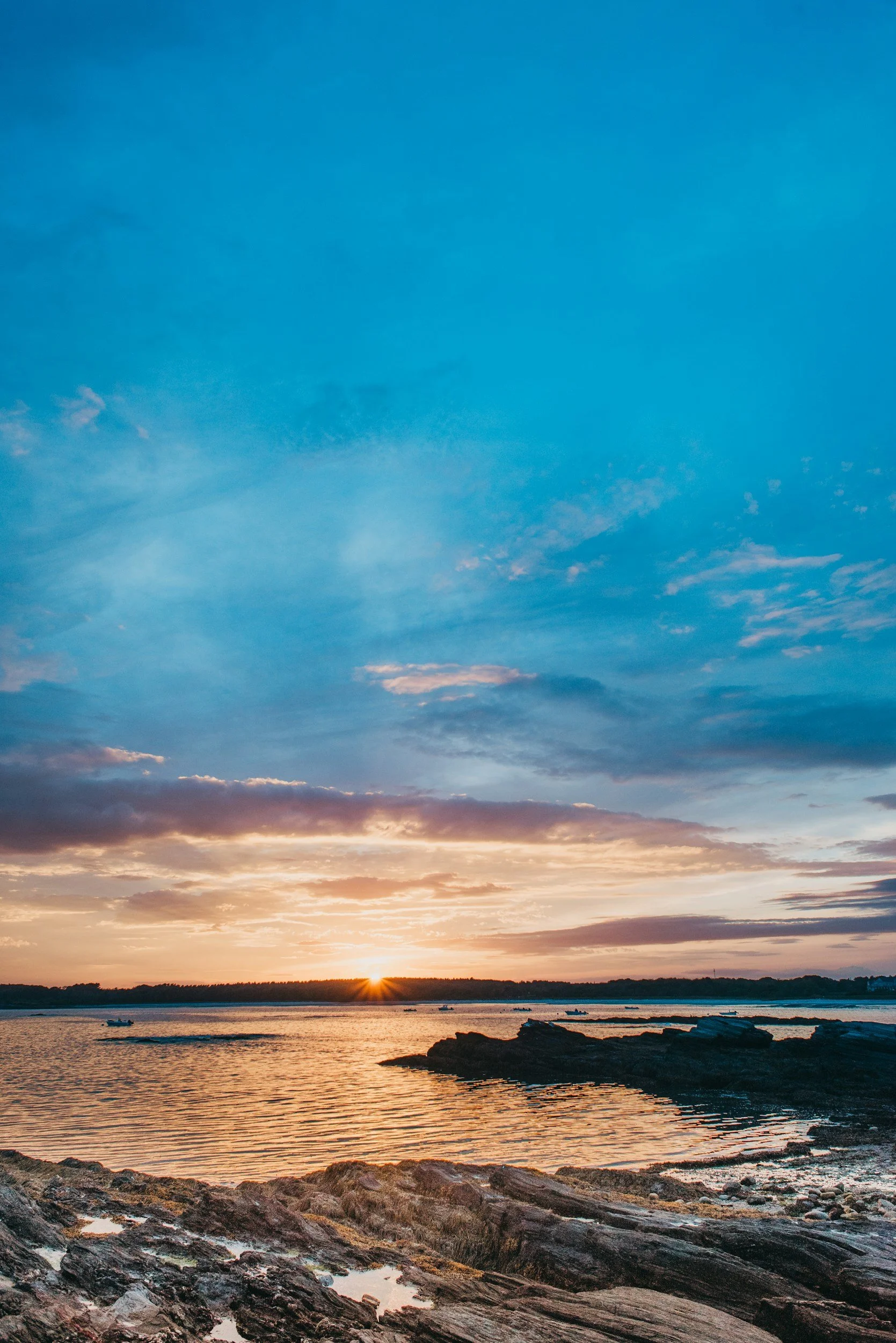 Soft blue sky with wispy clouds over the Maine coast — an atmospheric image accompanying Lindsey Architects' guide to the hidden costs and realities of coastal Maine homeownership.
