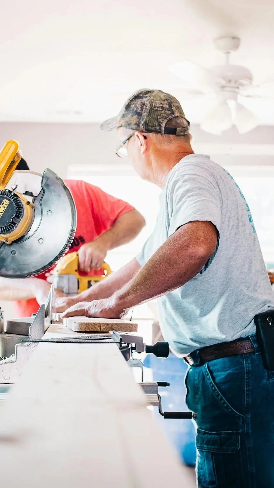 A craftsman carefully working on painted trim or millwork during a custom home renovation — illustrating the skilled, purposeful craftsmanship Lindsey Architects coordinates for historic and coastal home renovations in the New Hampshire Seacoast.