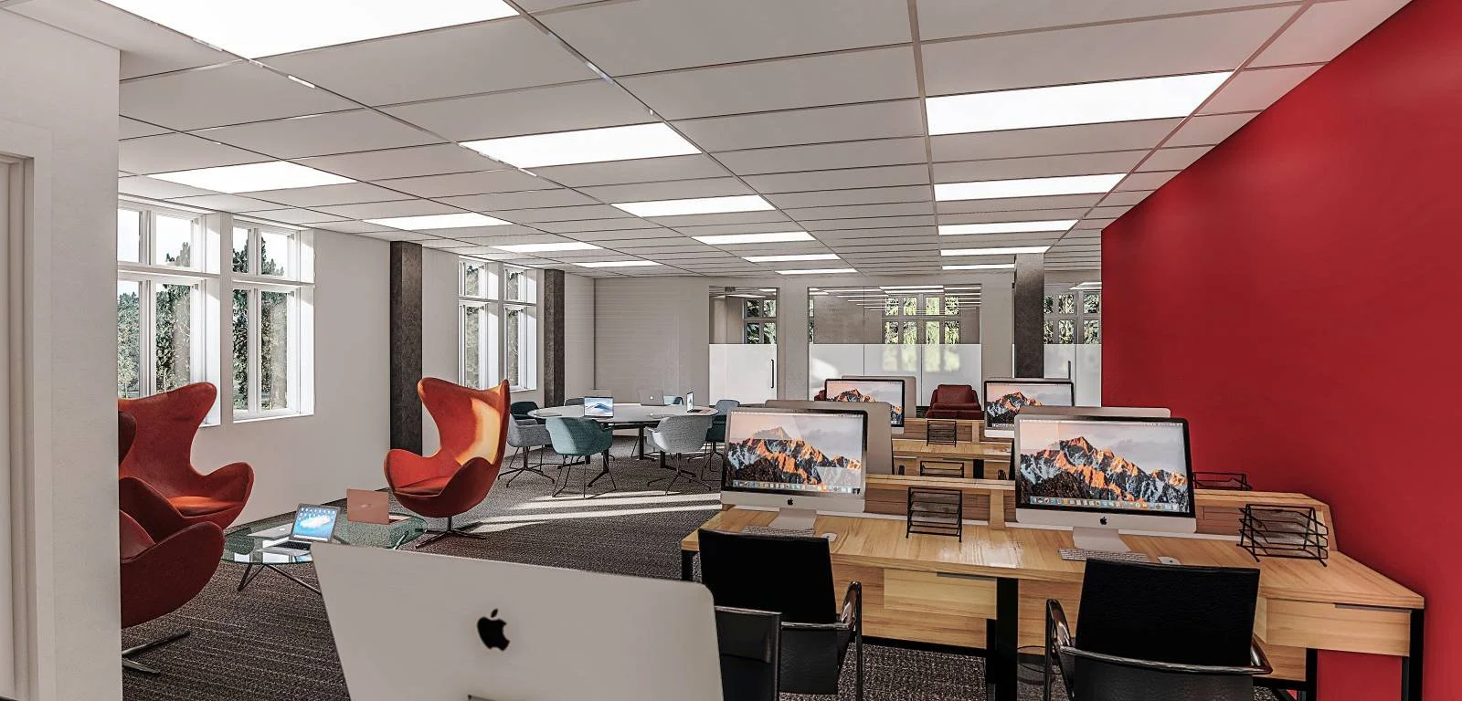 Modern open-concept corporate office featuring a bold red accent wall, collaborative workstations with dual monitors, contemporary red egg lounge chairs in a casual meeting area, recessed LED panel lighting, durable commercial-grade flooring, and lar