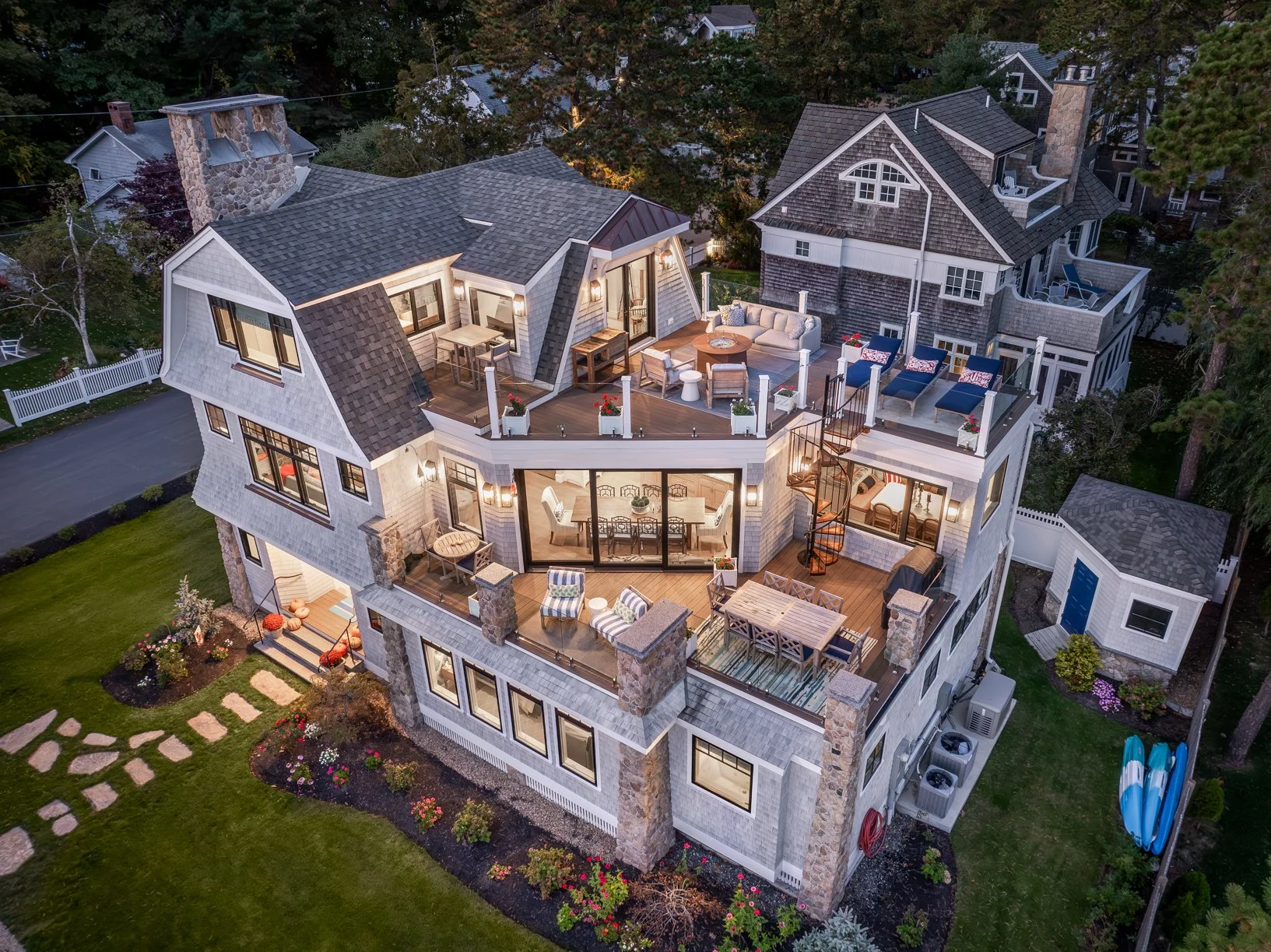 An expansive luxury coastal residence designed by Lindsey Architects, thoughtfully composed around layered outdoor terraces, panoramic waterfront views, and seamless indoor-outdoor living. This custom Maine home blends timeless New England architectu