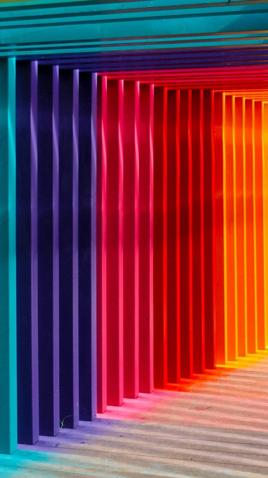 A rainbow-gradient light installation of vertical fins, a decorative image in a Lindsey Architects post on strategic use of color in design.