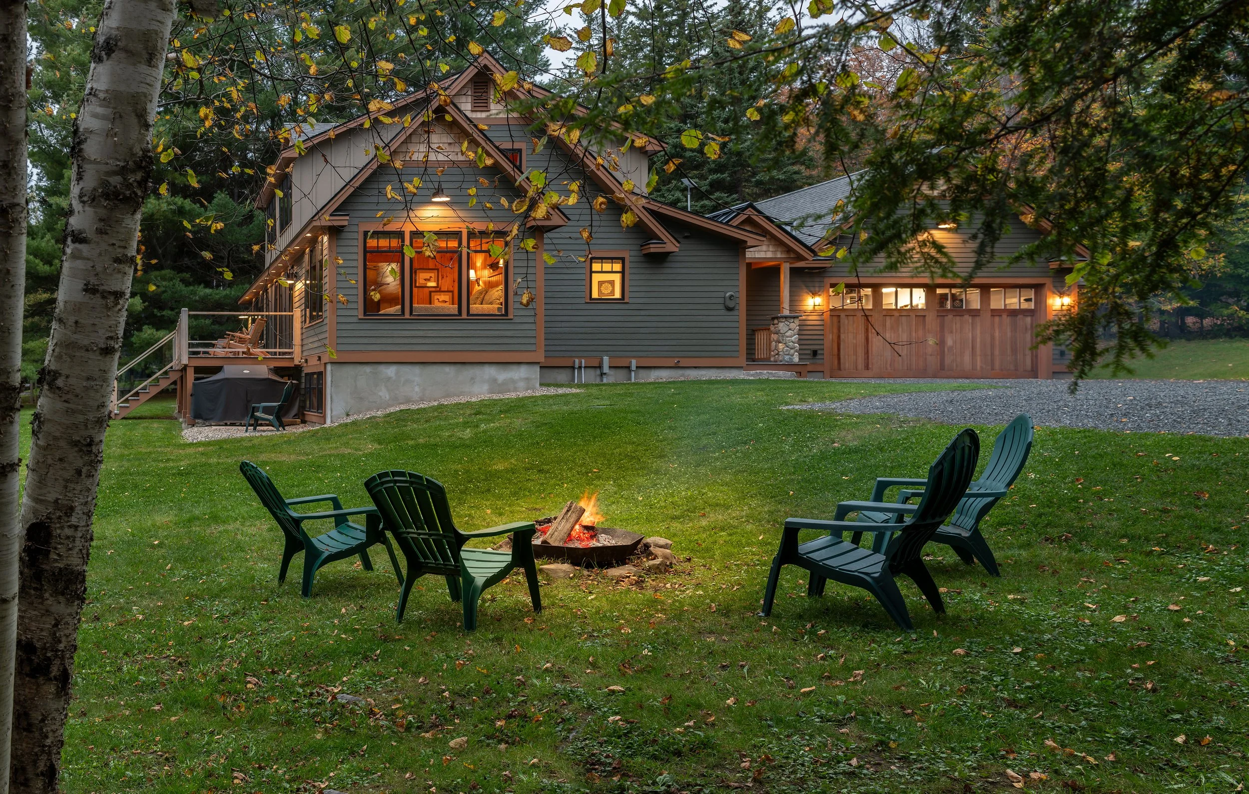 A custom woodland retreat designed by Lindsey Architects, blending warm natural materials, contemporary rustic detailing, and timeless New England architecture within a serene Maine forest setting. Expansive windows, exposed timber accents, and caref