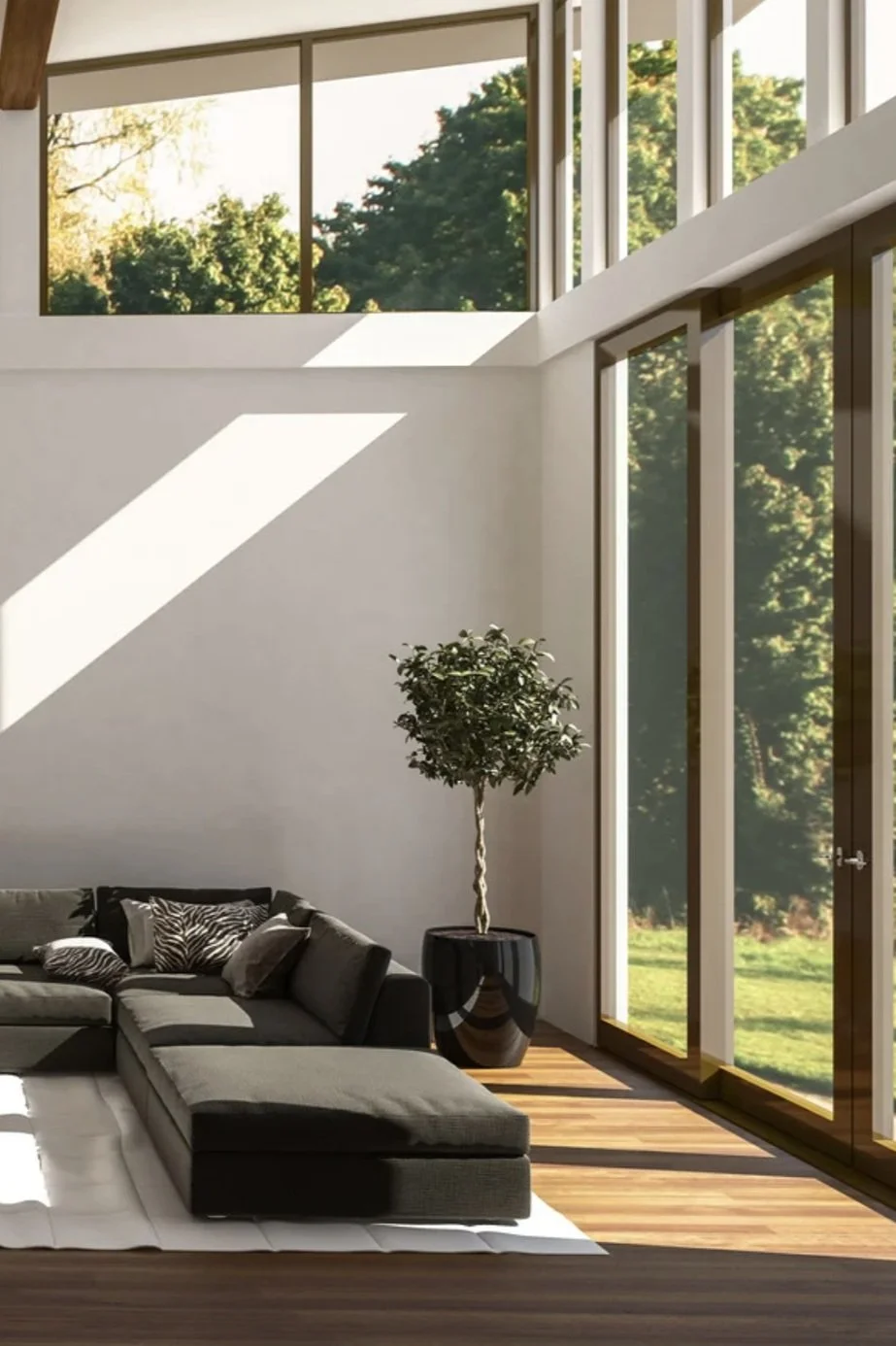 Sun-filled living room with floor-to-ceiling windows and natural light streaming across the wall, designed by Lindsey Architects in York, Maine.
