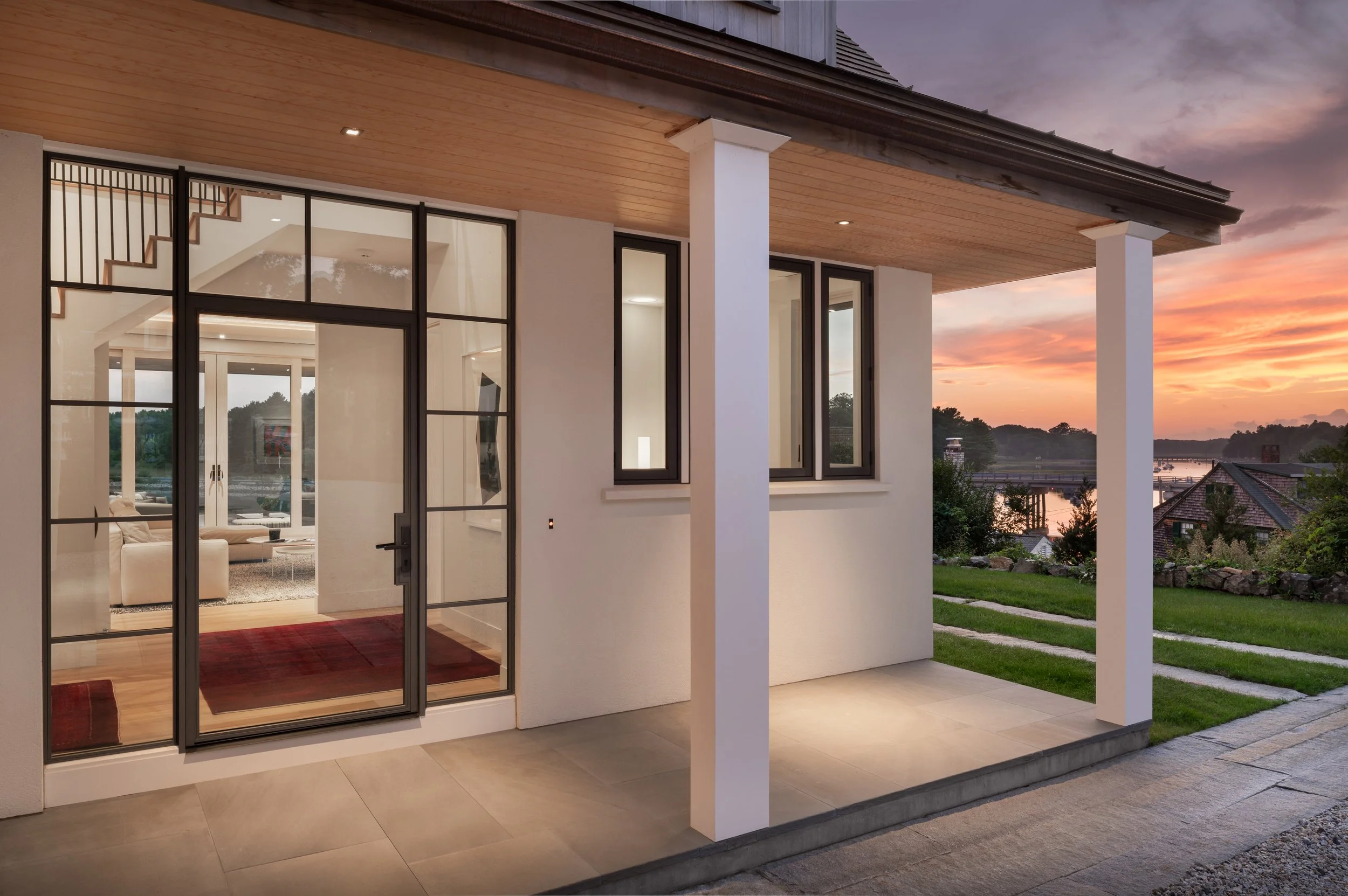 Lindsey Architect's new custom home design, featuring a modern entry and a traditional roofline