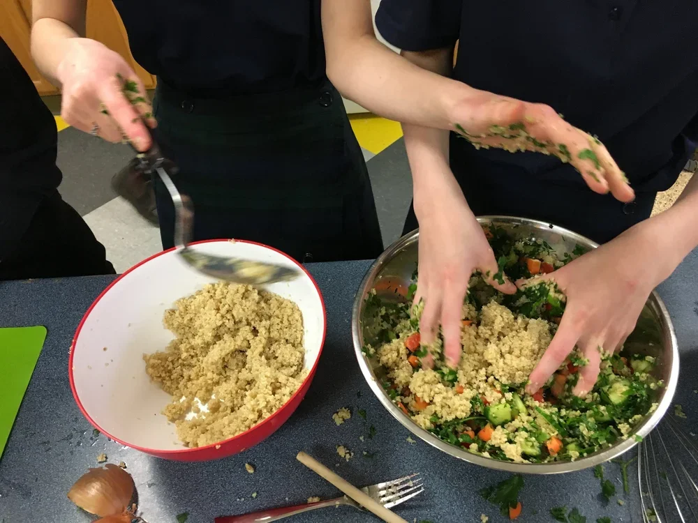 Hands mixing ingredients in a bowl