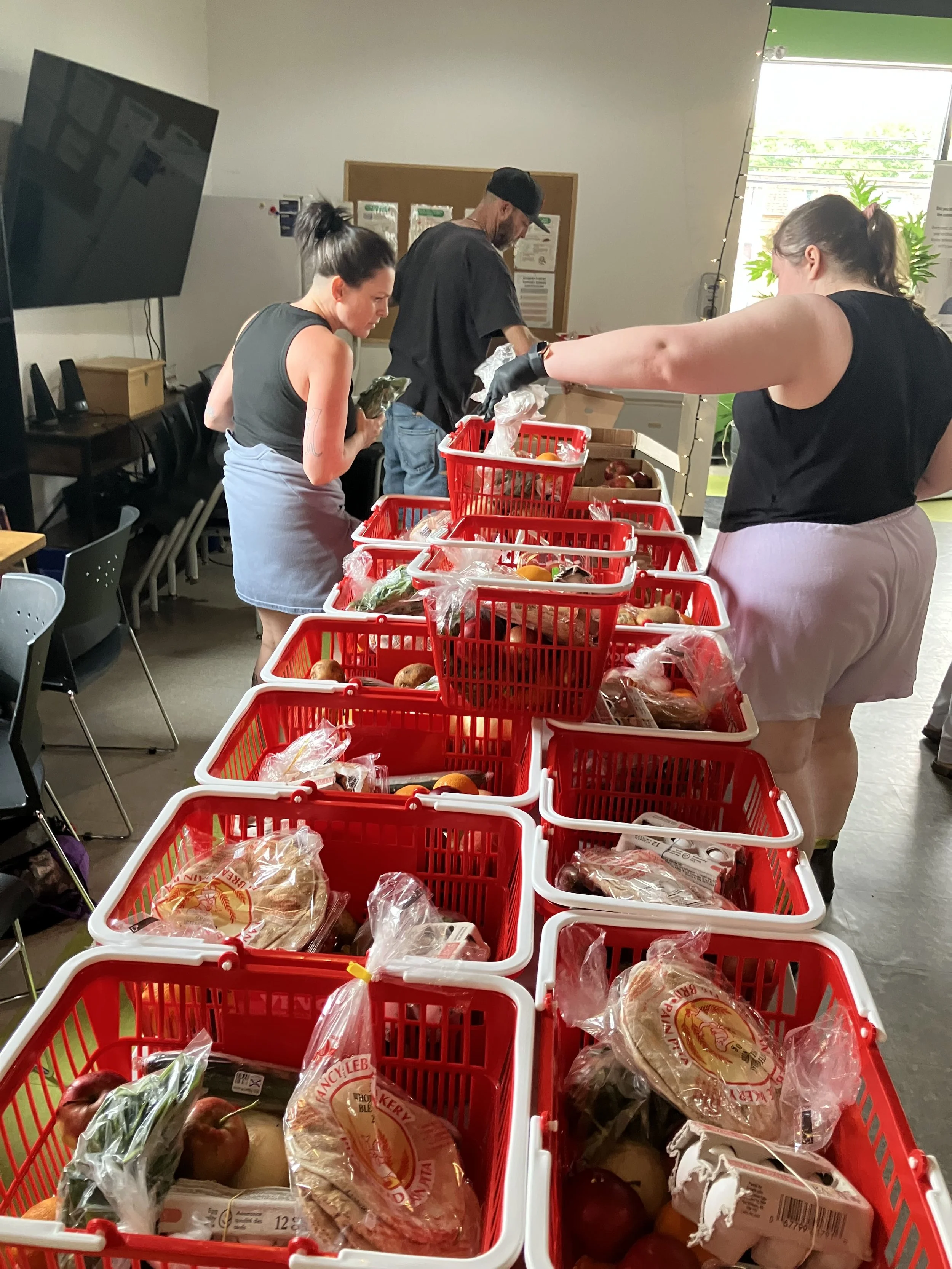 volunteers packing food baskets at community centre