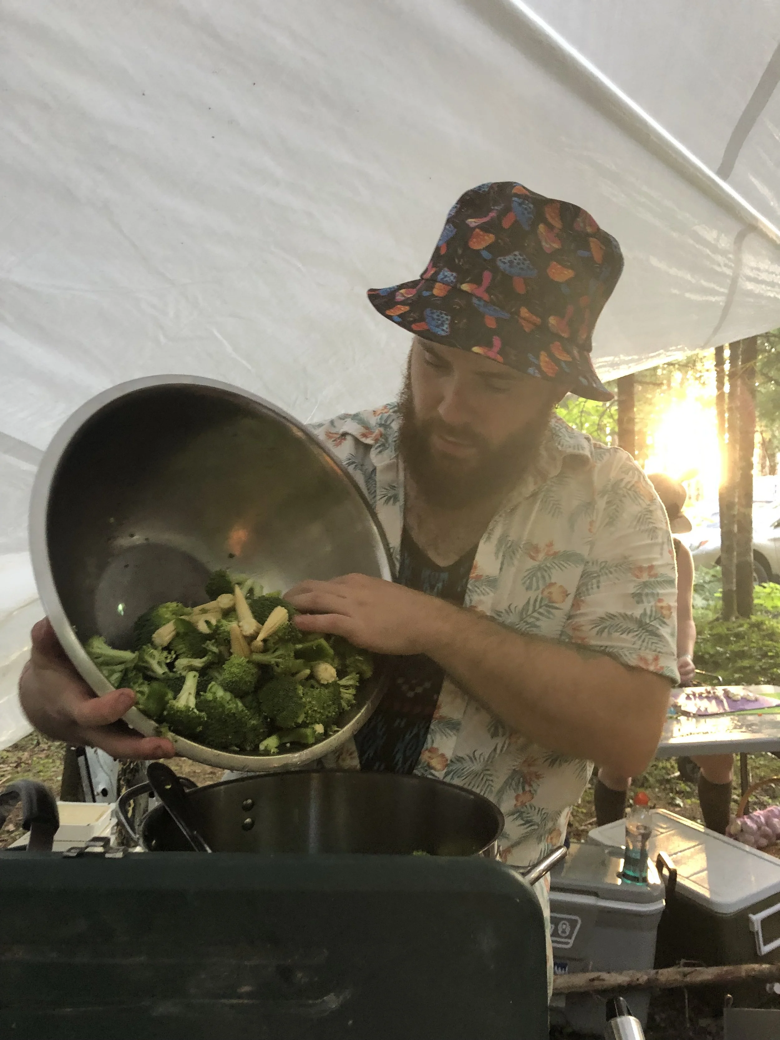 Chef Justin Andrews cooking outdoors for a music festival