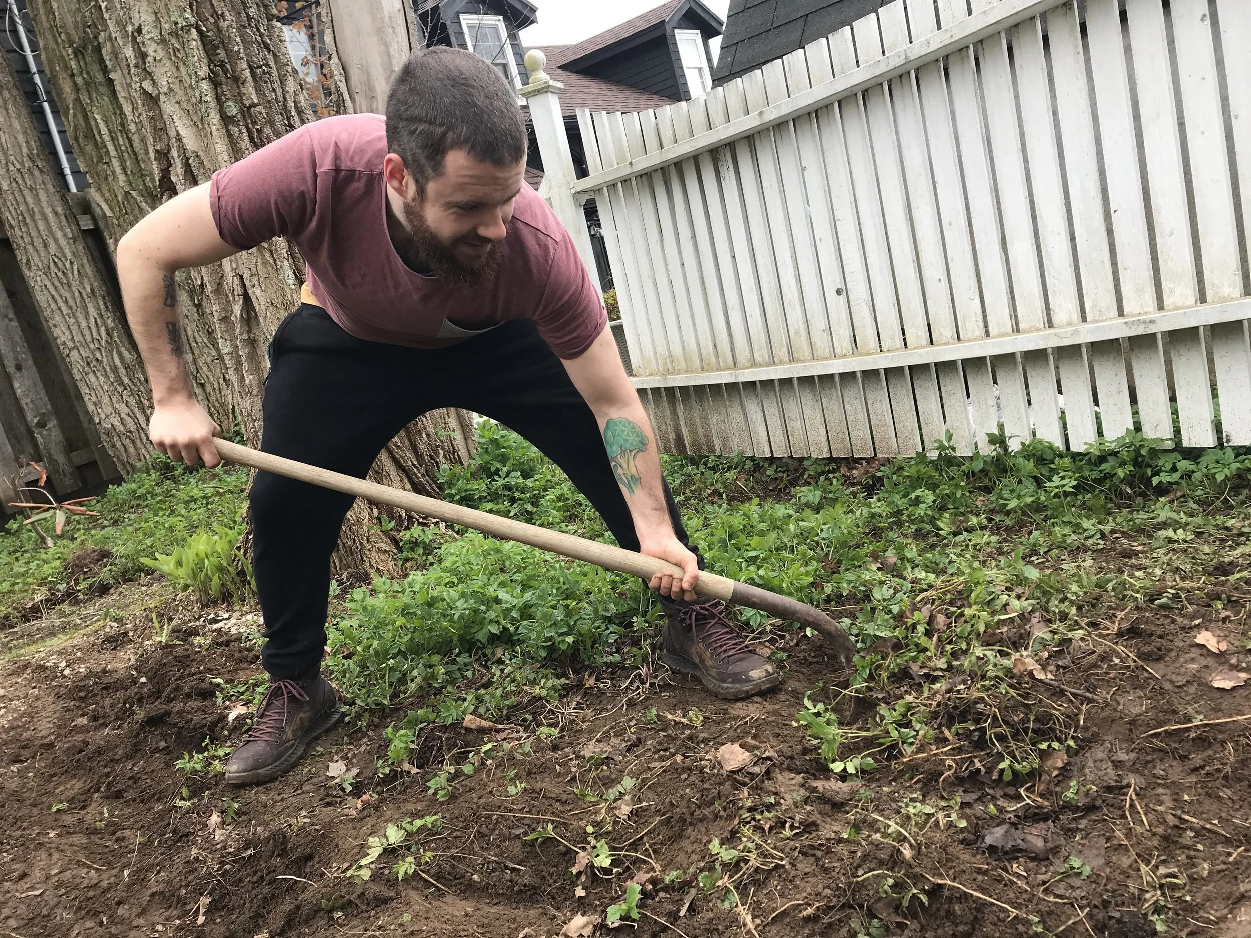 Chef Justin Andrews digging in the garden