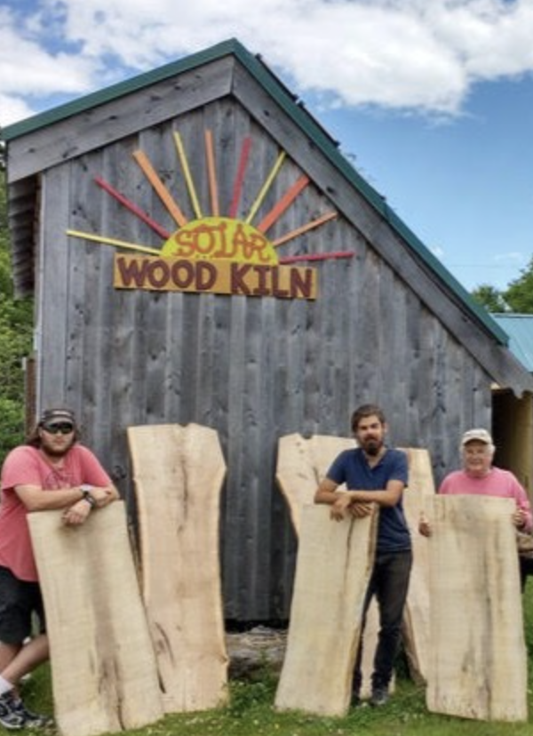 Shed with sign reading "solar wood kiln"